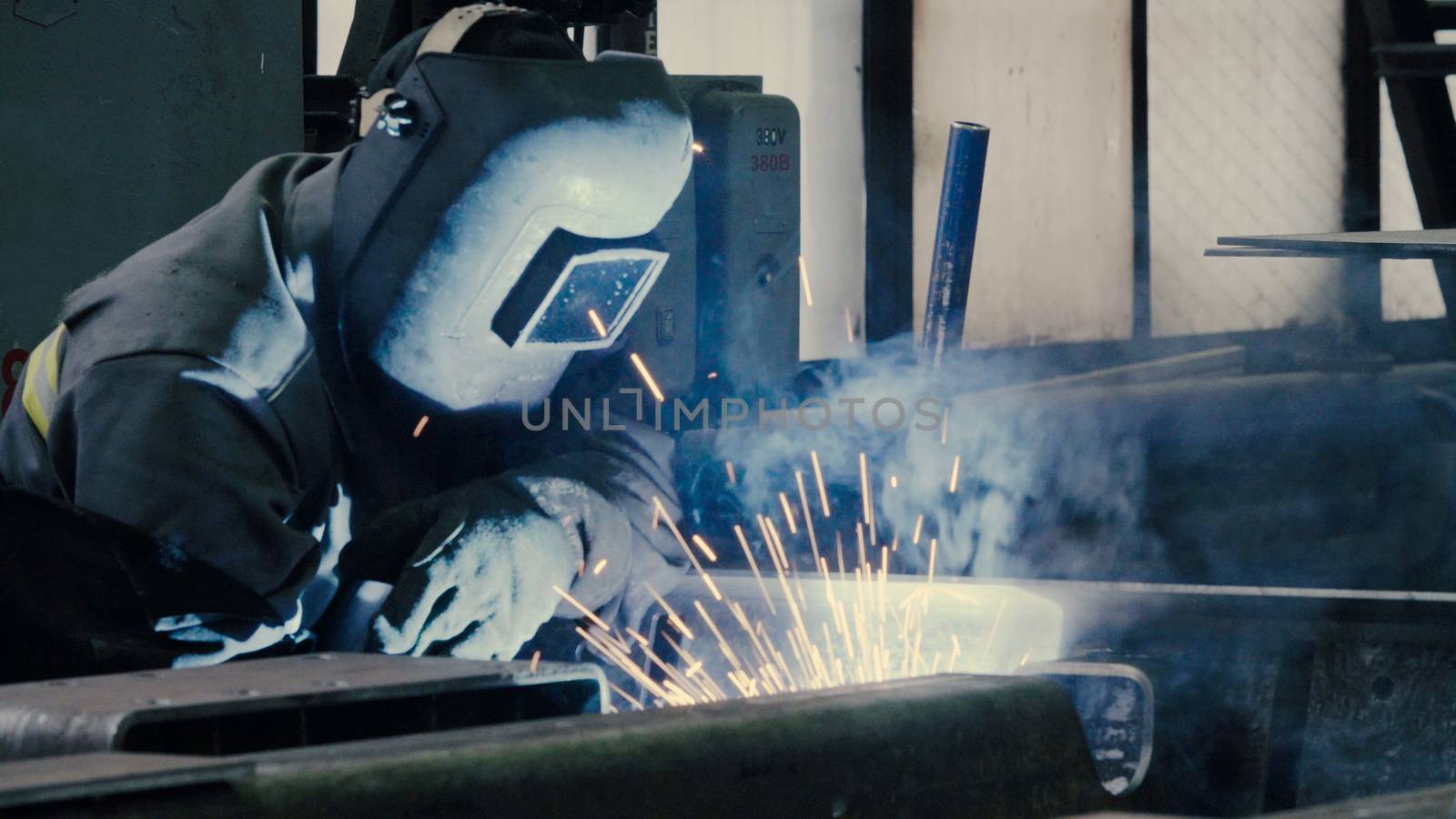 Welder at work in metal industry by Chudakov