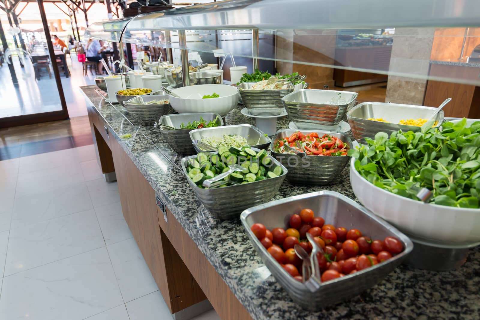 Buffet is a portioned salads on  table by olgavolodina