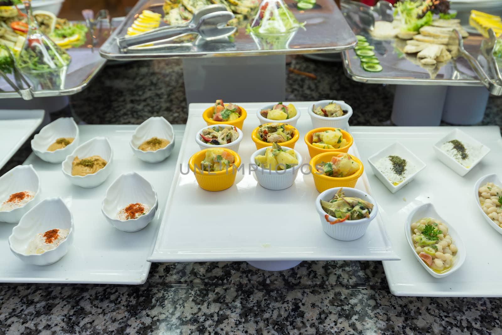 Buffetis a portioned salads on the table