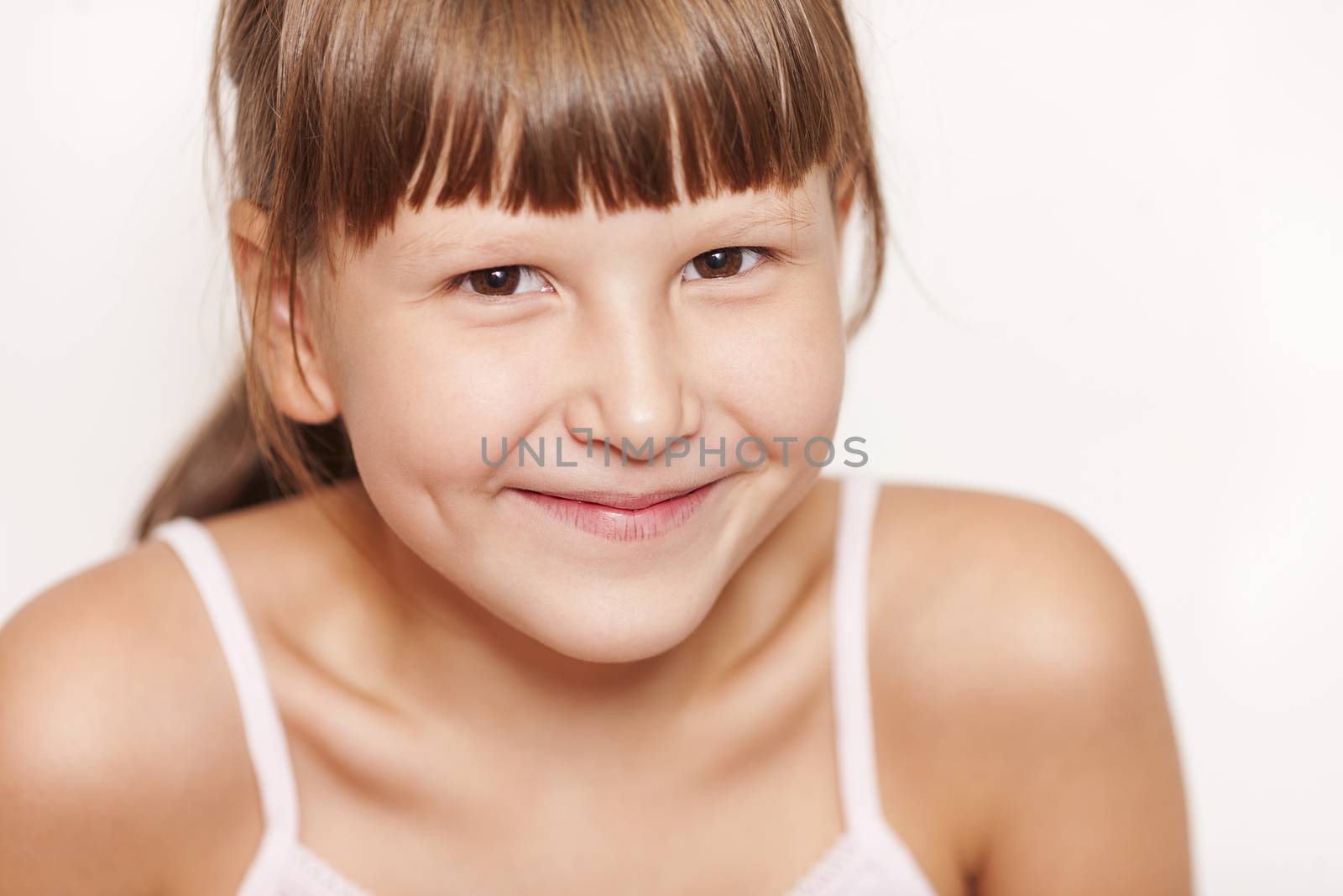 Happy Eight years girl wearing bangs closeup portrait