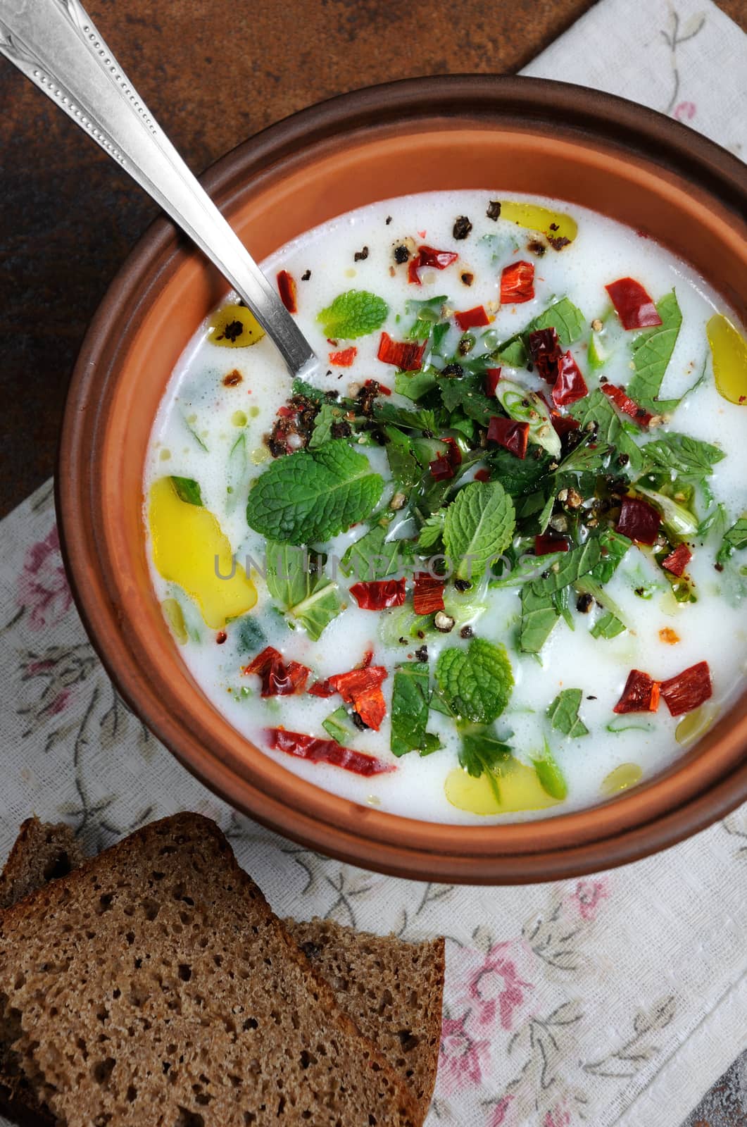  Refreshing сold summer soup the rice, mint and yoghurt, spices.  Vertically shot. View from above.