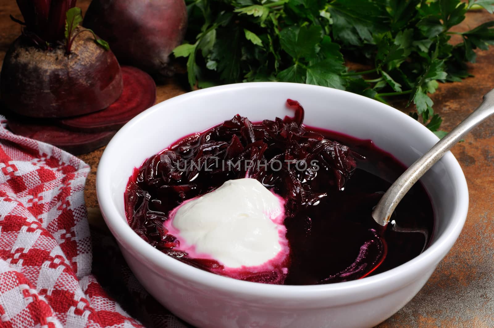 A dish of beet soup with sour cream. Horizontal shot.