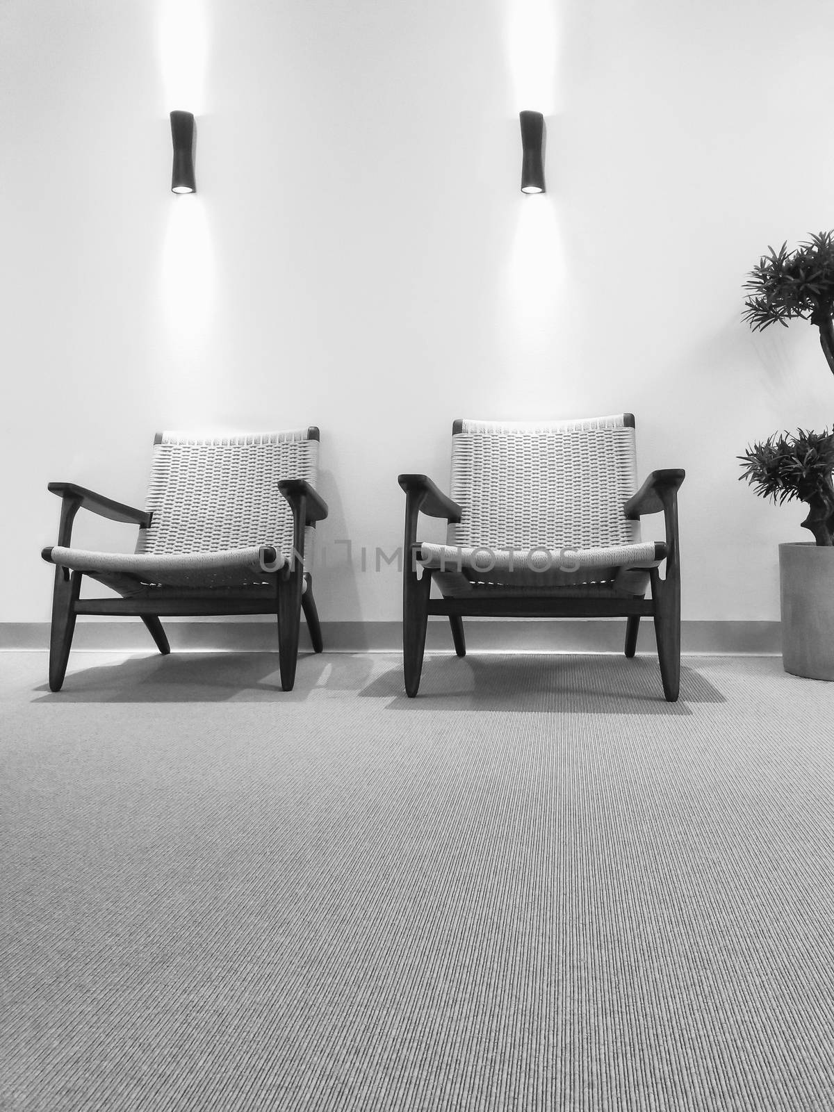 Black and white interior with rattan chairs by anikasalsera