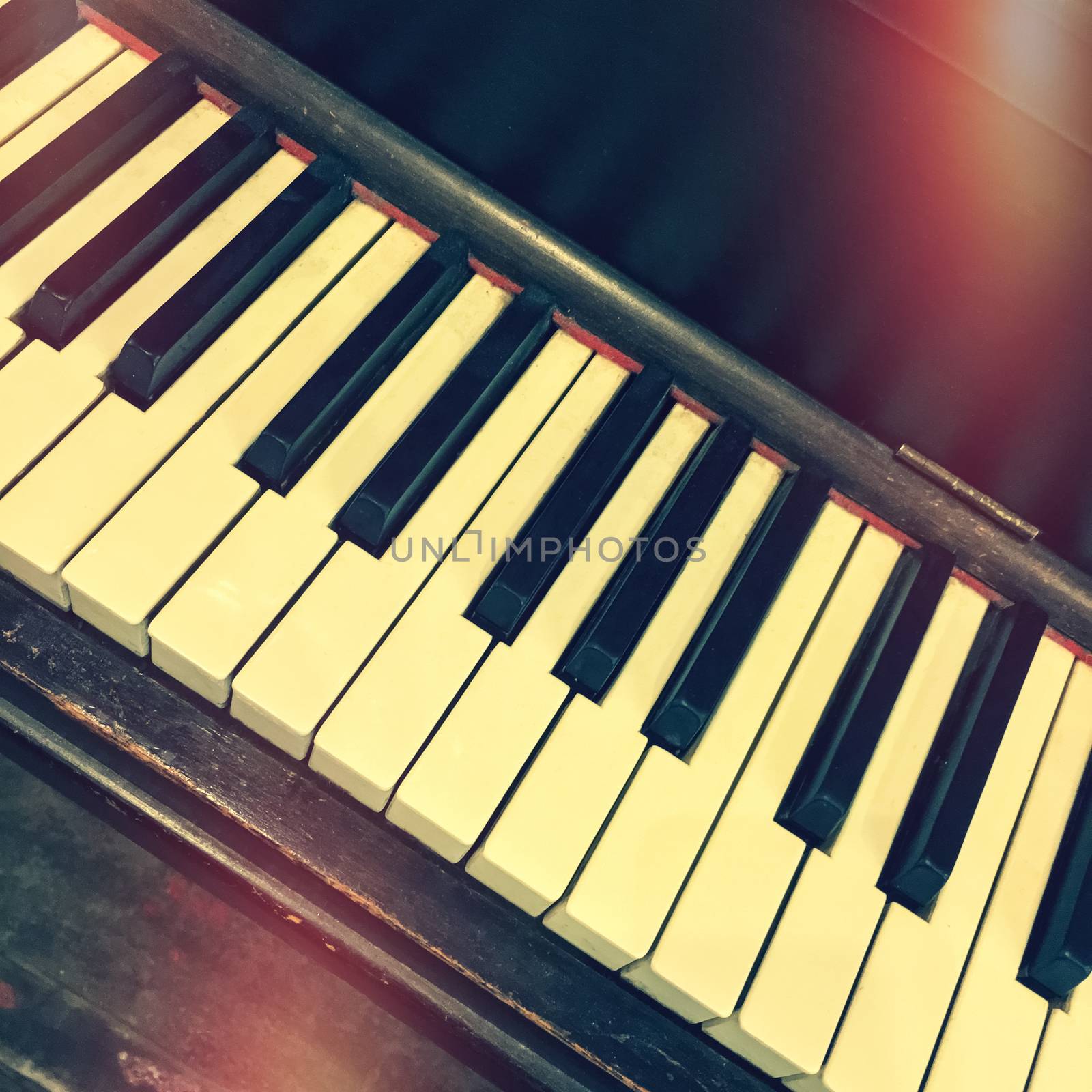 Piano keys. Retro style photo with light leaks.