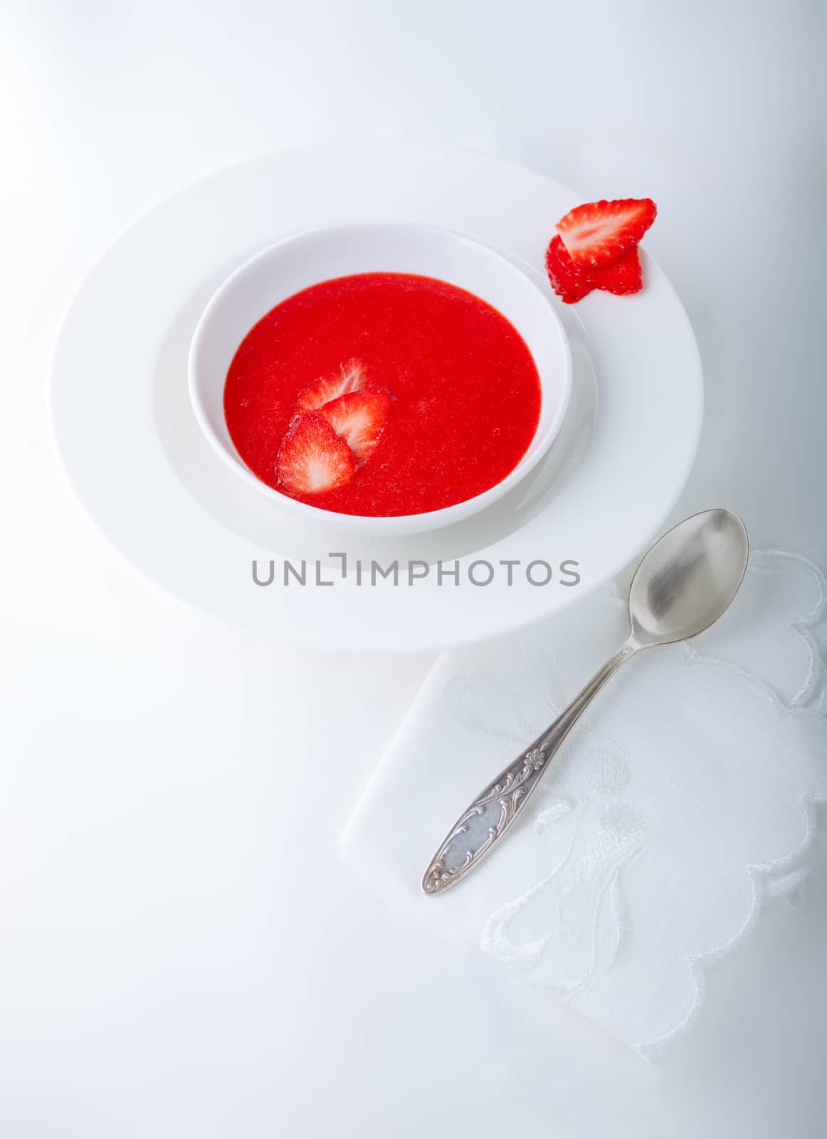 Strawberry soup with white napkin on a table. by supercat67