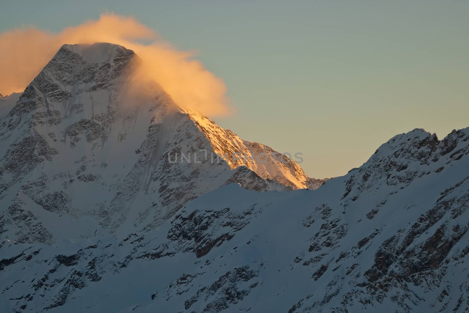 Snow peaks of the mountains in the evening