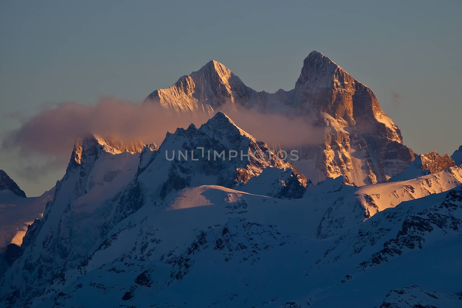 Snow peaks of the mountains in the evening
