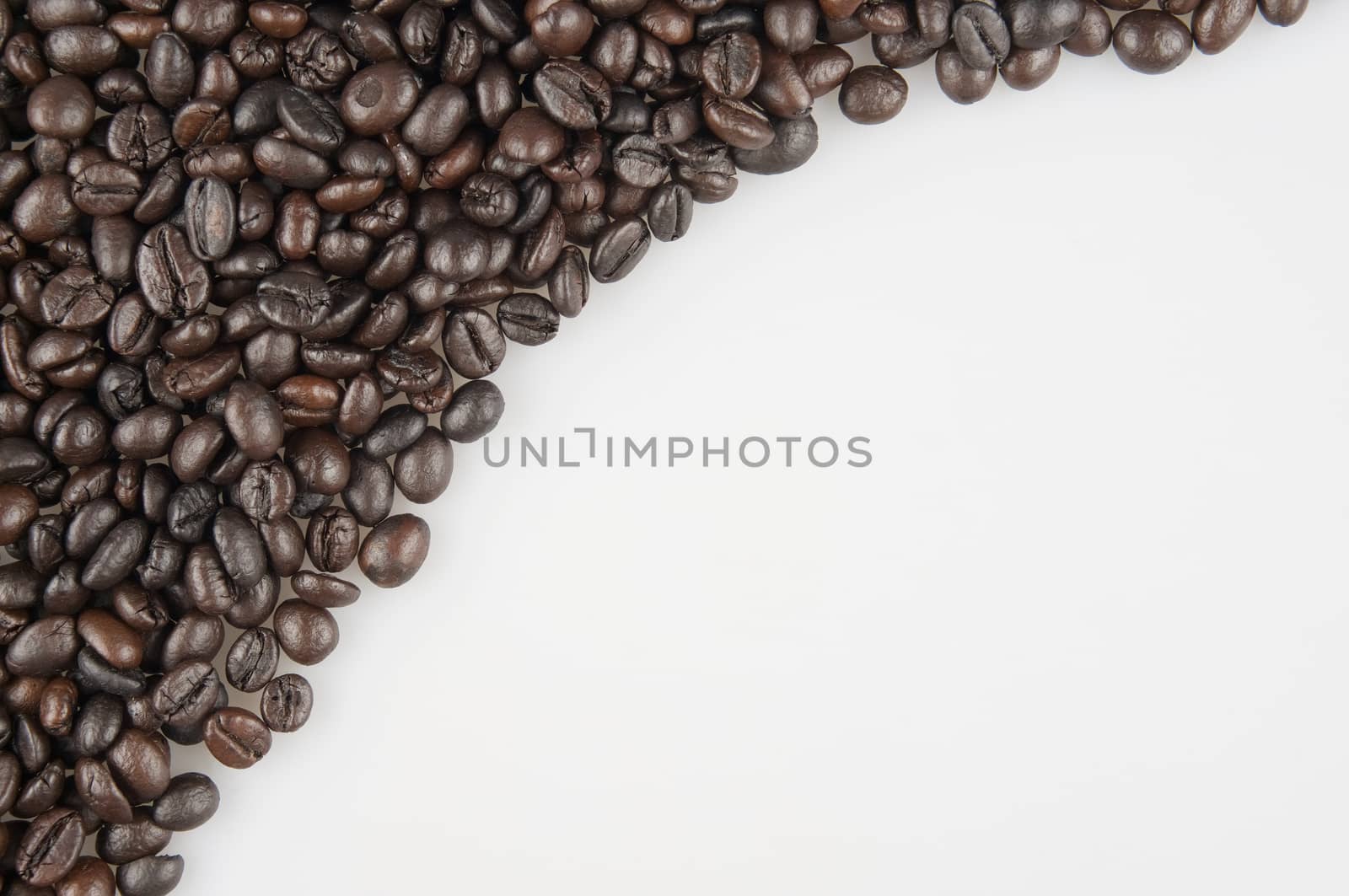 Roasted coffee beans have white space on right use as texture or background.