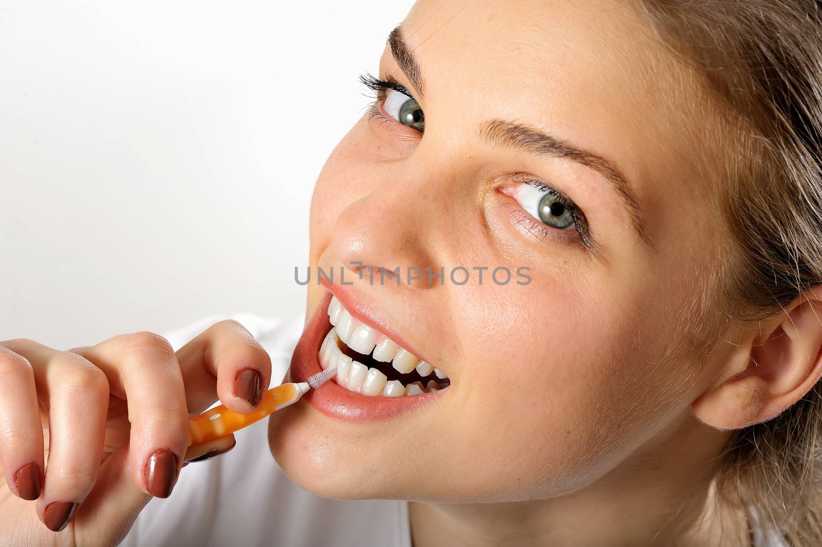 Girl using Interdental Brush for teeth  hygiene