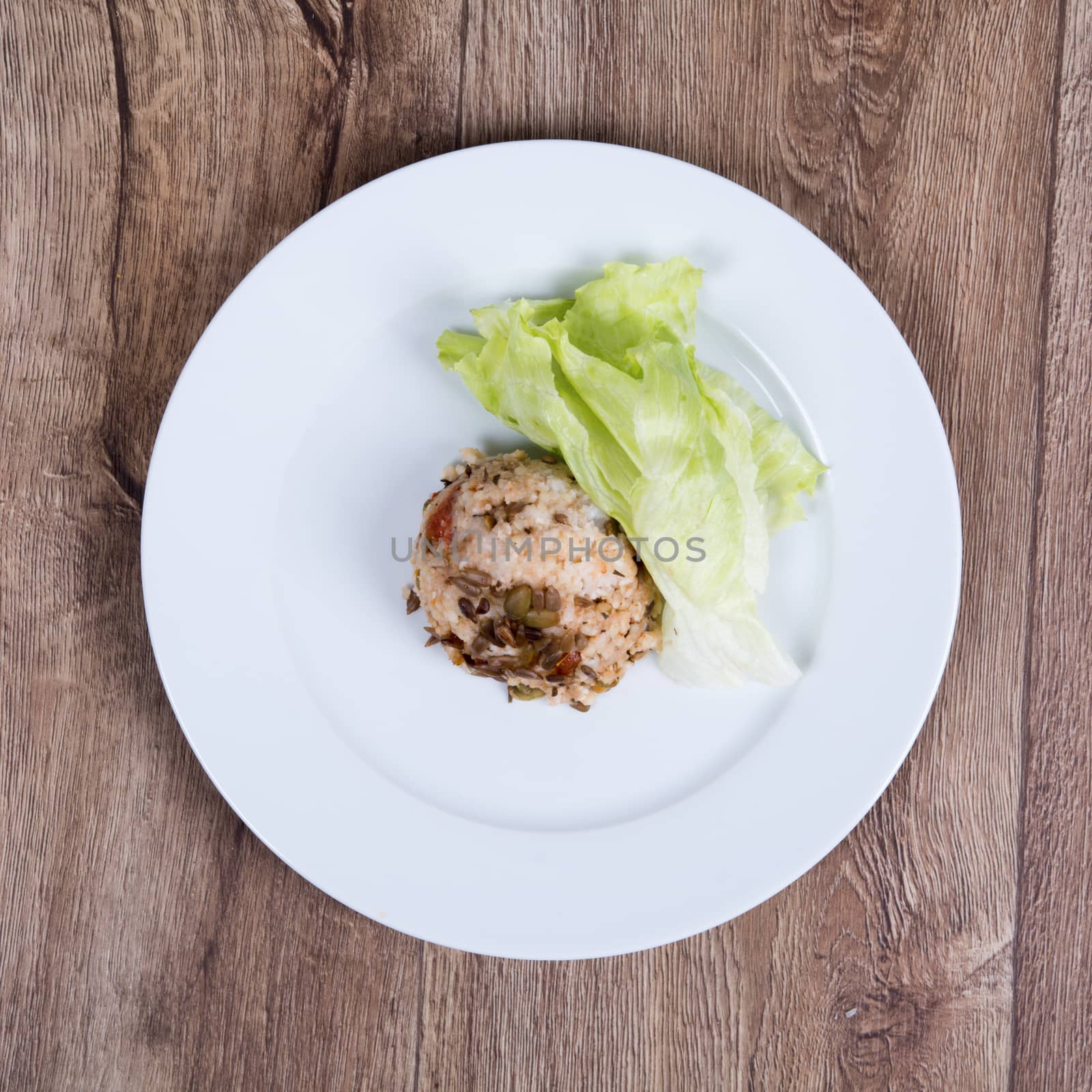 Vegetarian food on a plate with wooden background by neryx