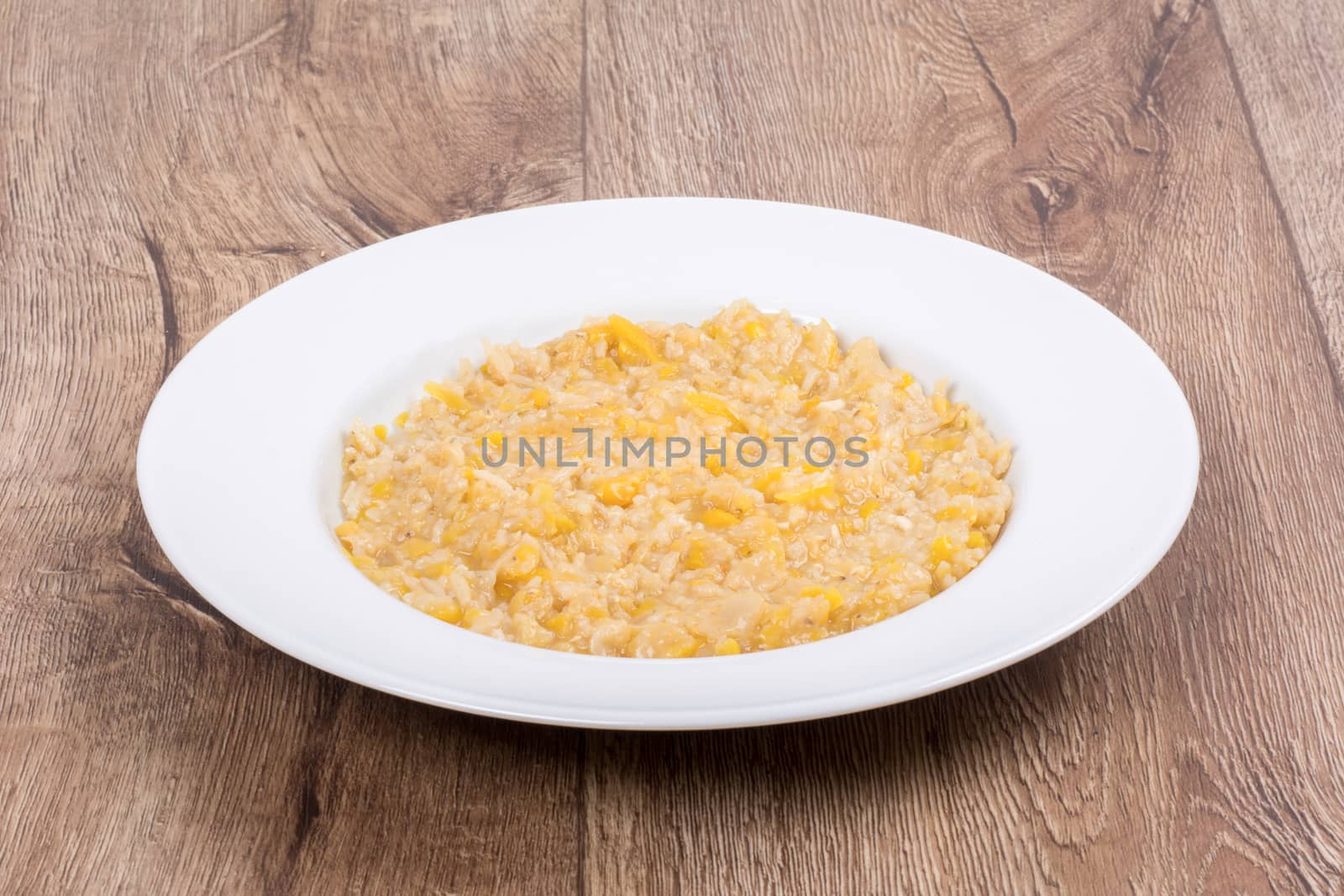 Vegetarian food on a white plate with wooden background