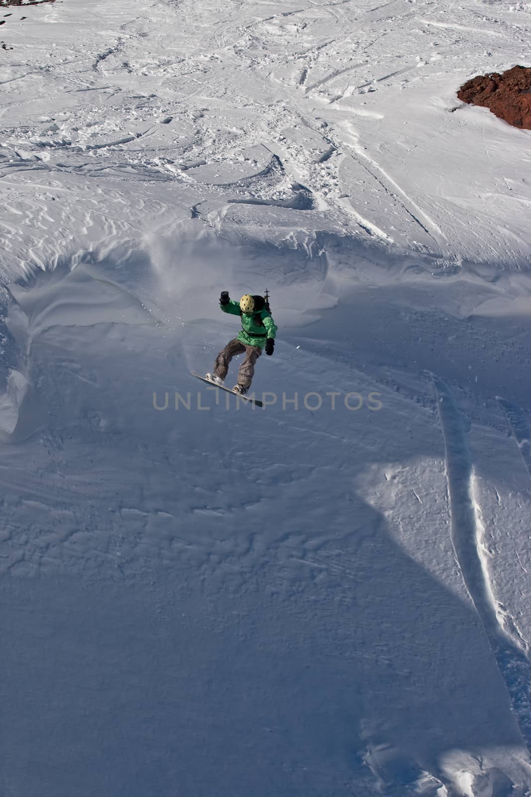 Snowboard freeride. Freerider jumping in the mountain