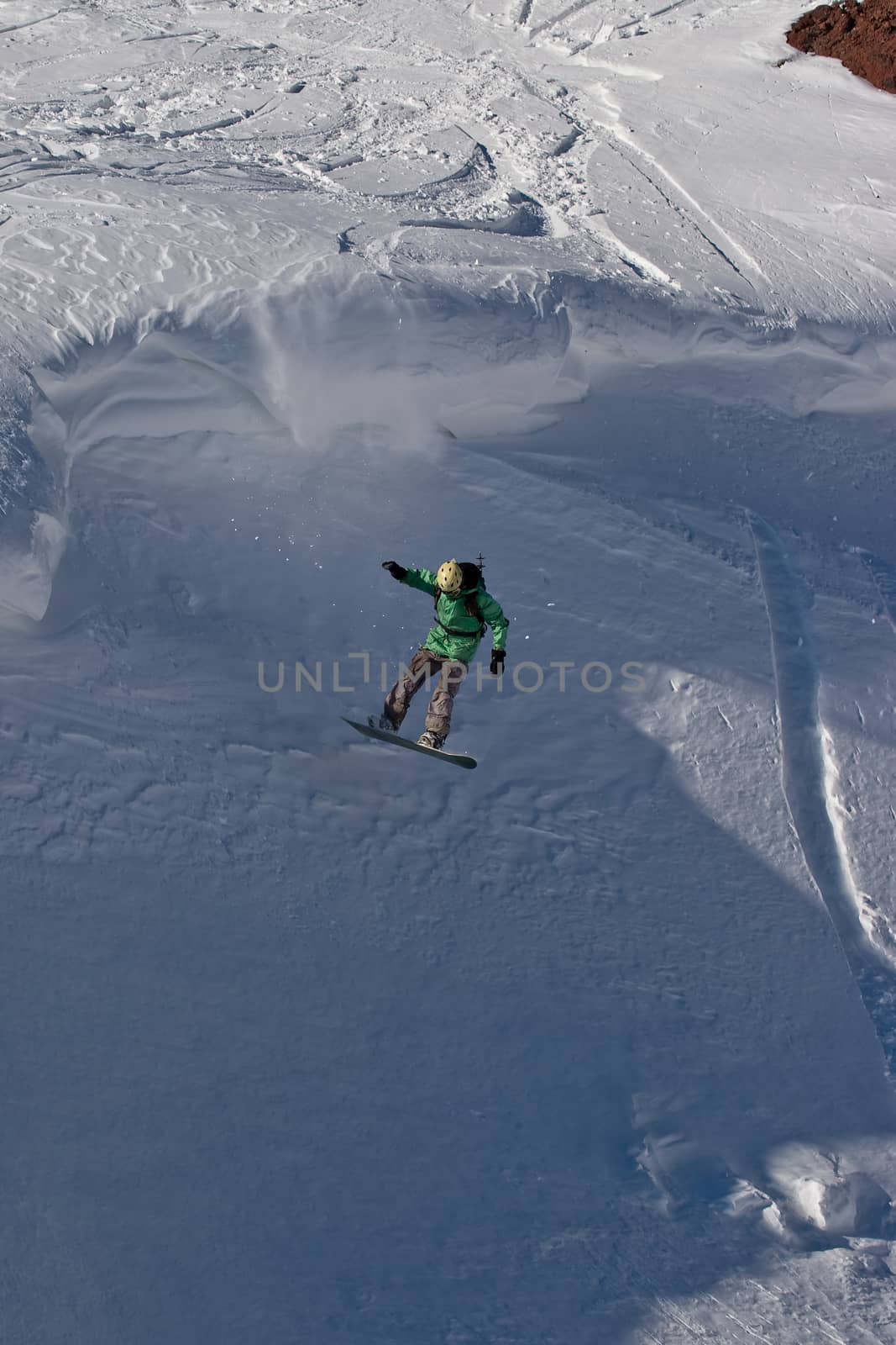 Snowboard freeride. Freerider jumping in the mountain