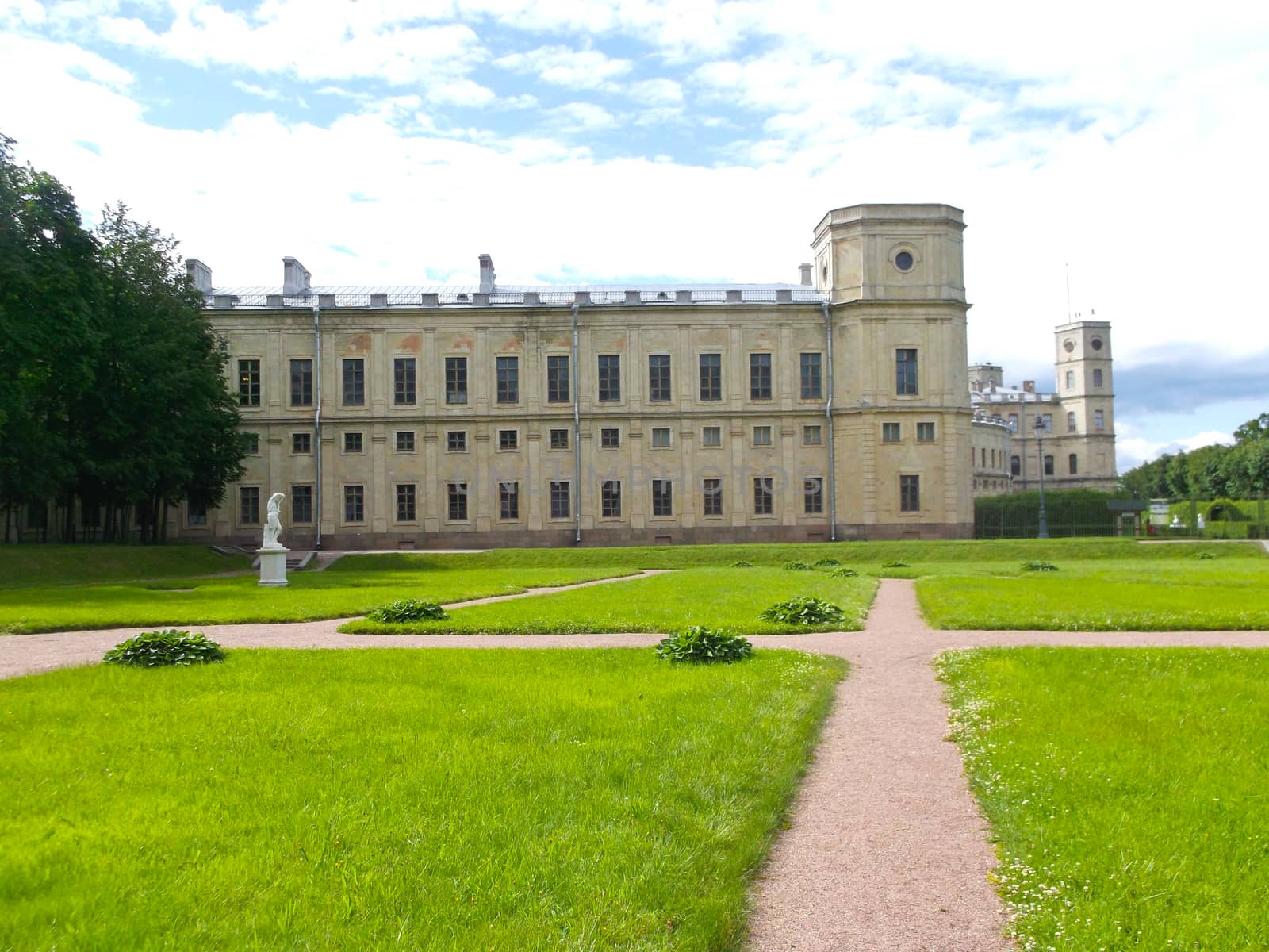 green lawn in front of the Big Gatchina Palace on a background of blue sky