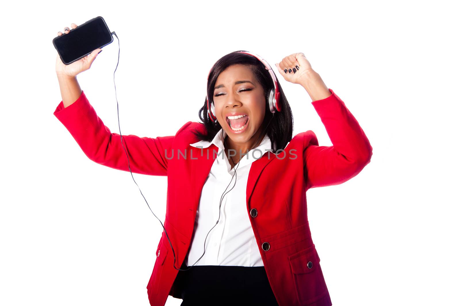 Beautiful happy business woman jamming singing listening to music on wireless mobile phone, on white.