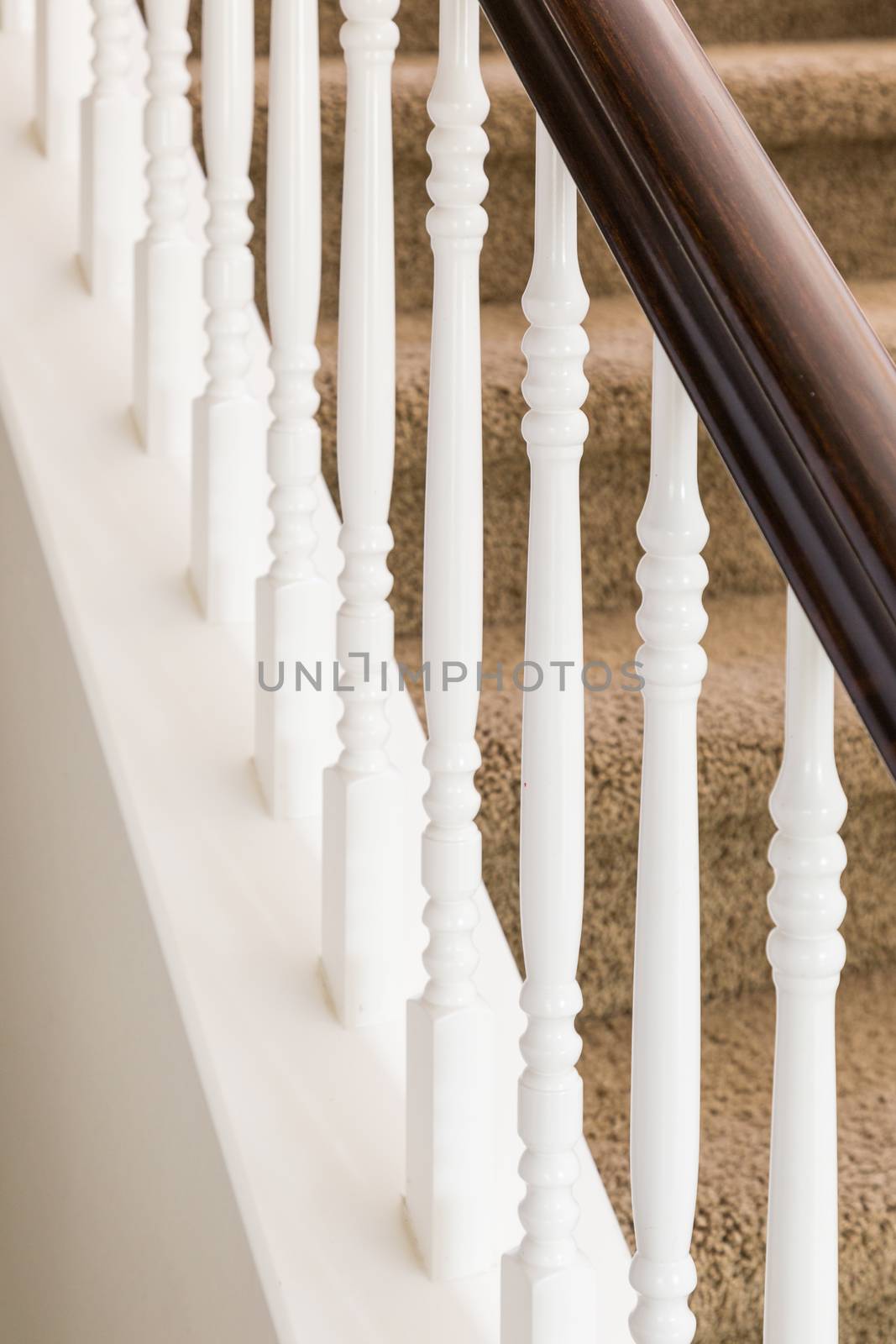 Abstract of Beautiful Stair Railing and Carpeted Steps in House.