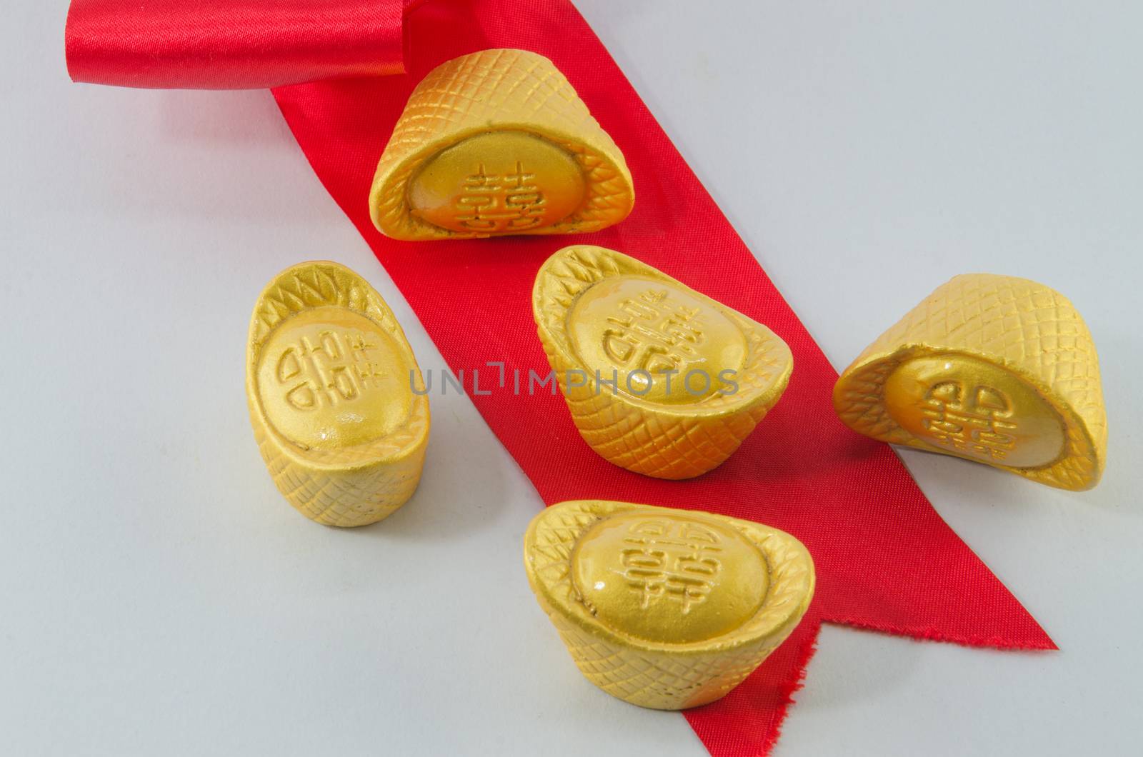 Gold ingot Red ribbon bow on white background.