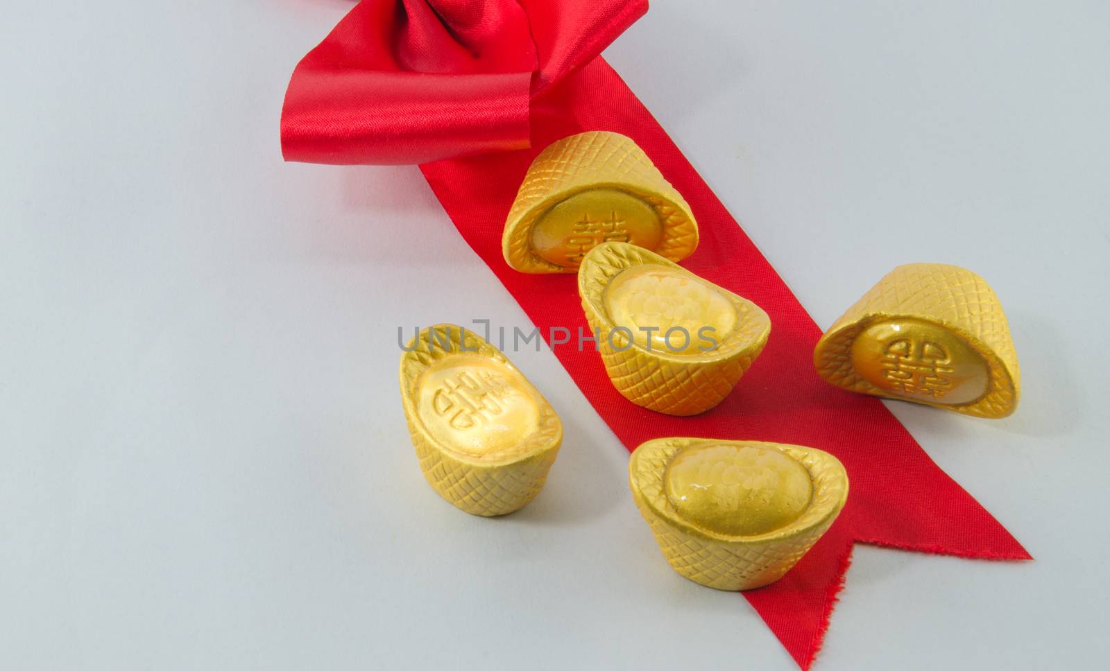 Gold ingot Red ribbon bow on white background. by metal22