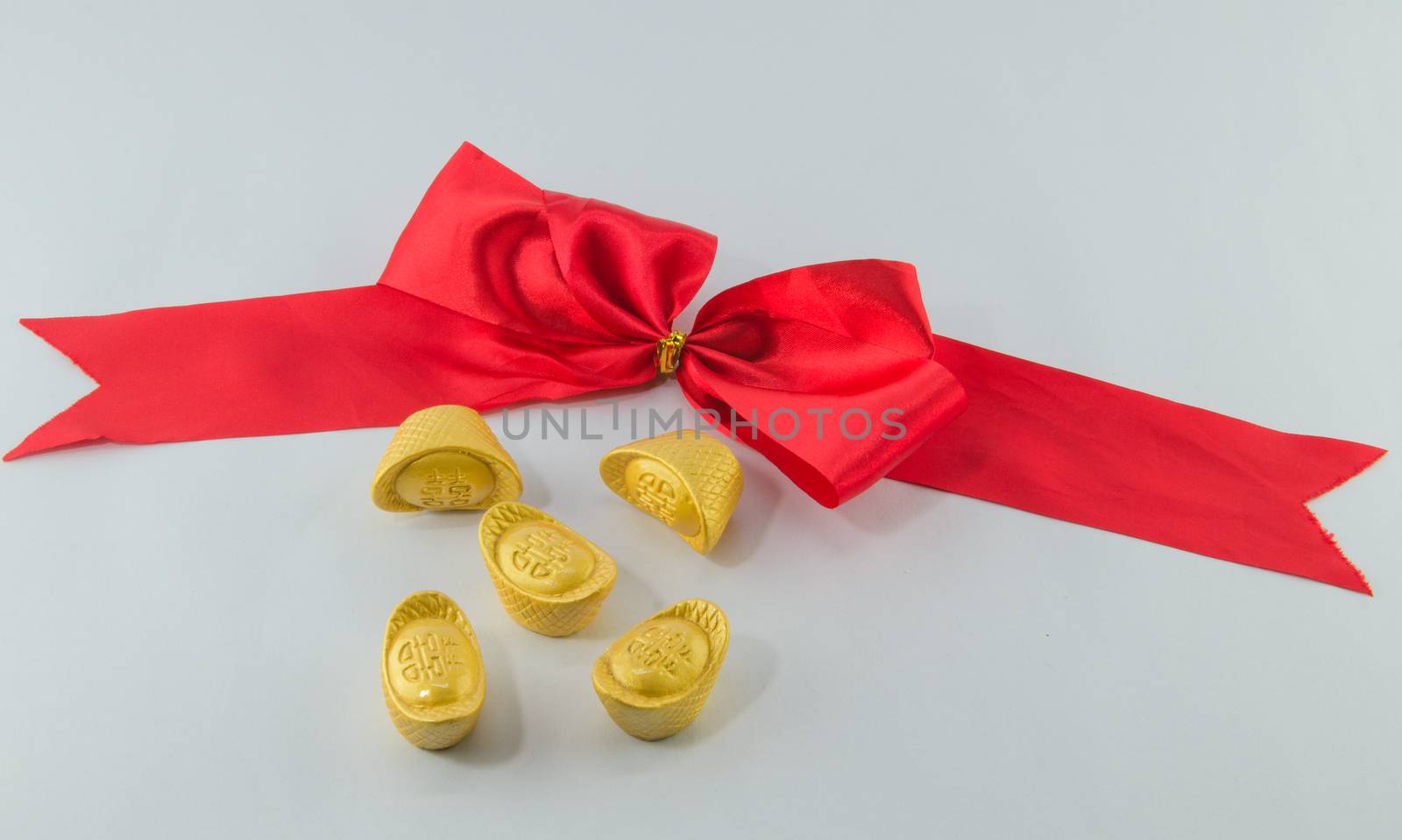 Gold ingot Red ribbon bow on white background.