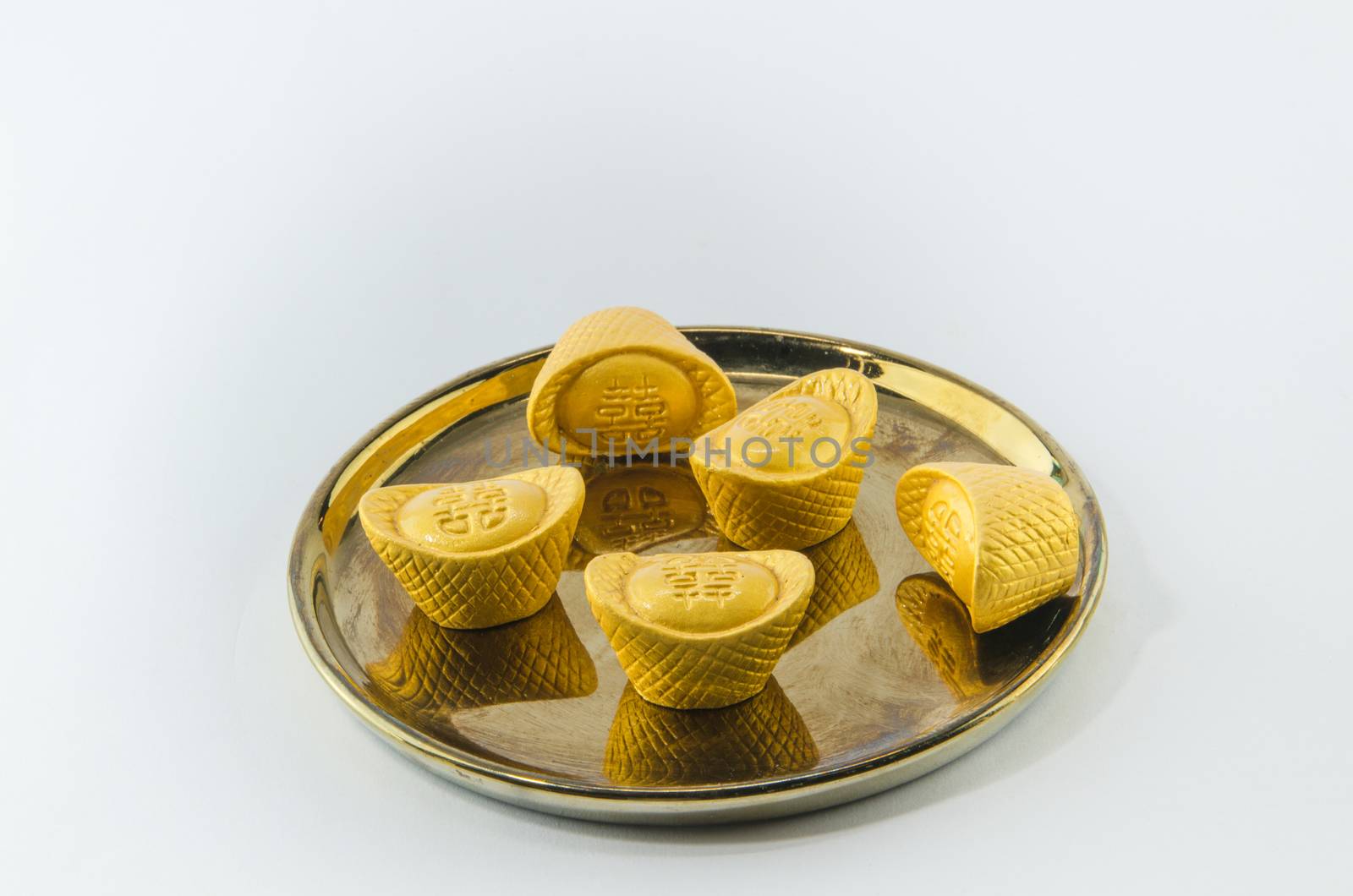 Gold ingot on golden plates white background