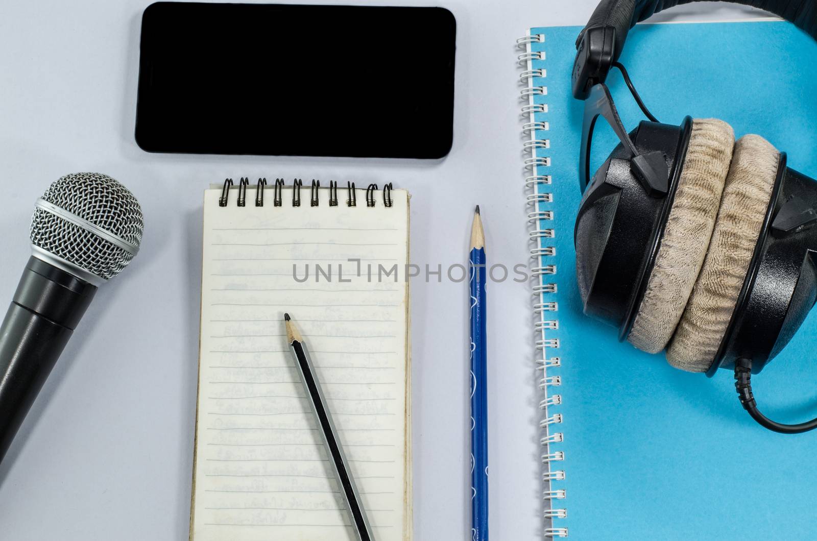 blank notebook in top view with music concept 
whitebackground headphones