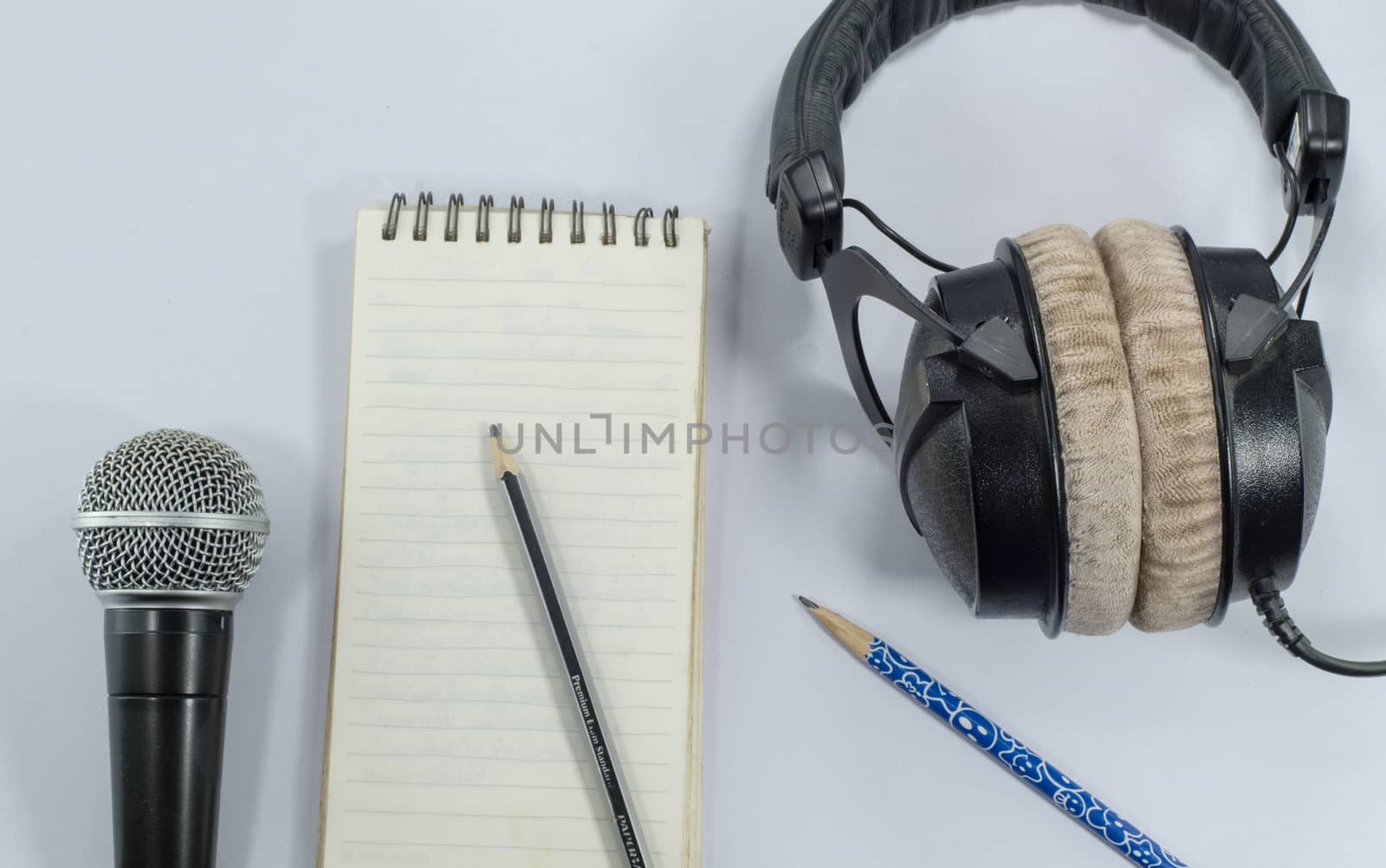 blank notebook in top view with music concept 
whitebackground headphones