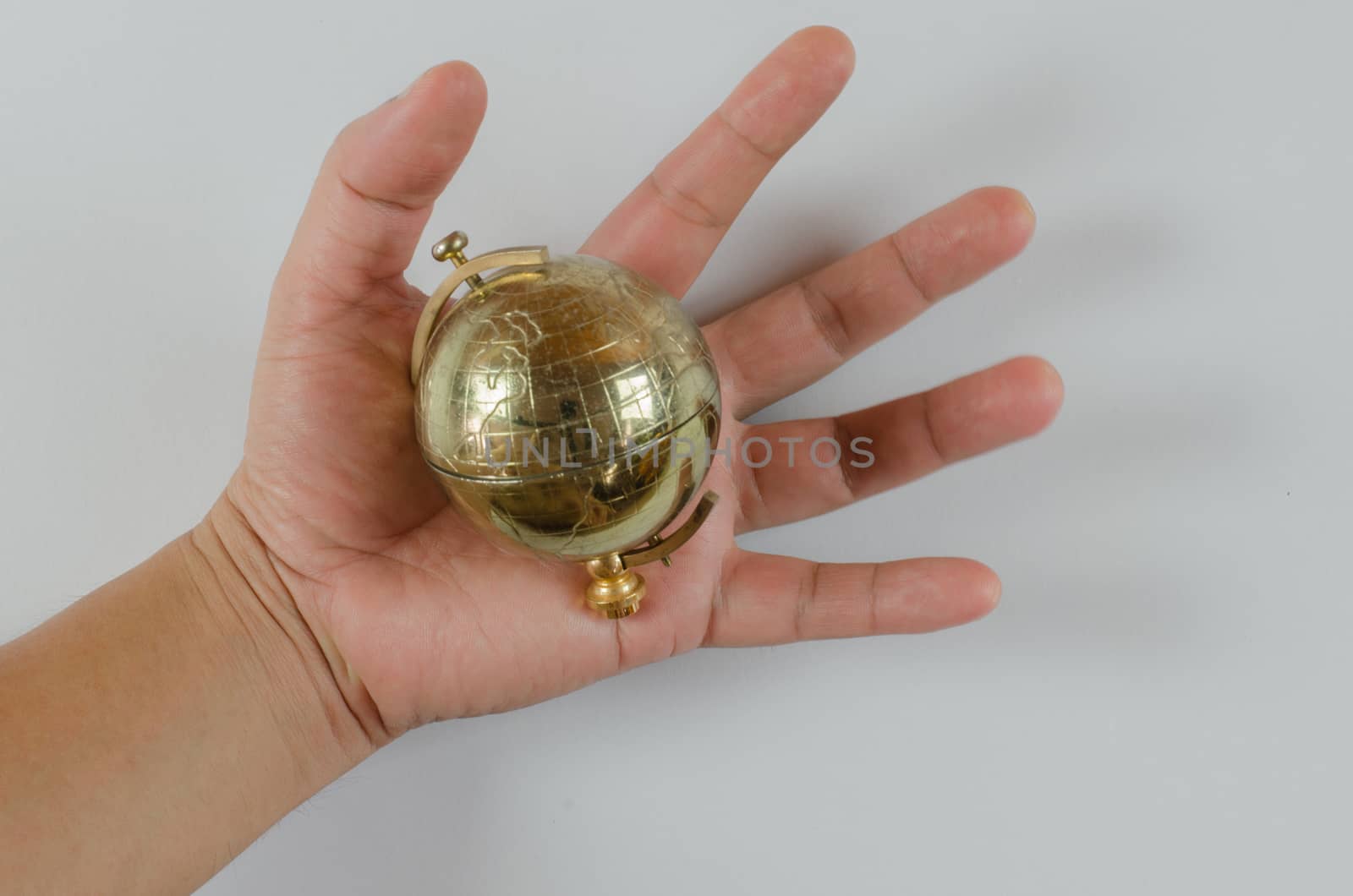 Golden Globe in hand isolated on white background