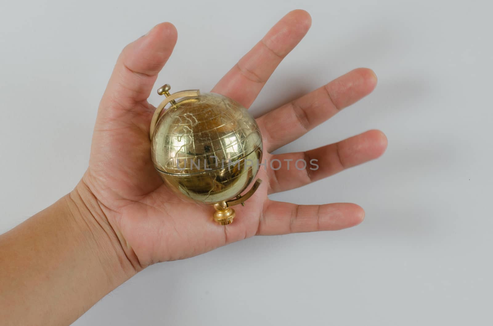 Golden Globe in hand isolated on white background  by metal22