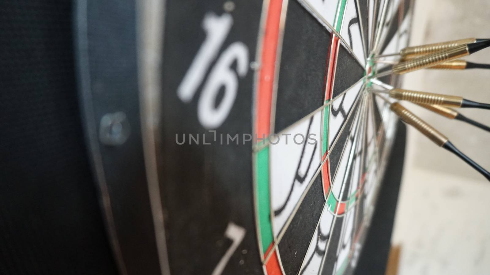 Business concept of darts. The target hanged on the wall.