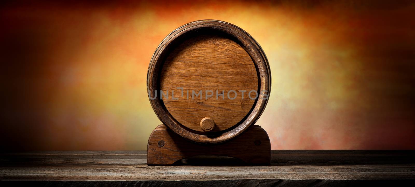 Wooden cask for liquid on old timber table 
