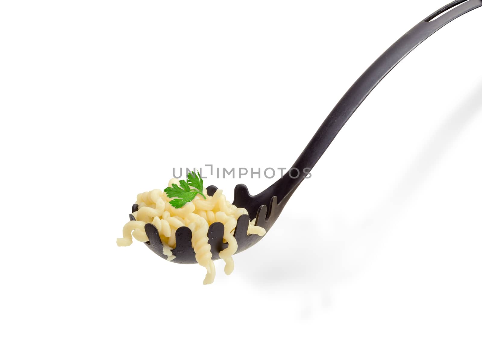 Some cooked helix shaped pasta and small parsley twig on the black plastic spaghetti spoon closeup on a light background
