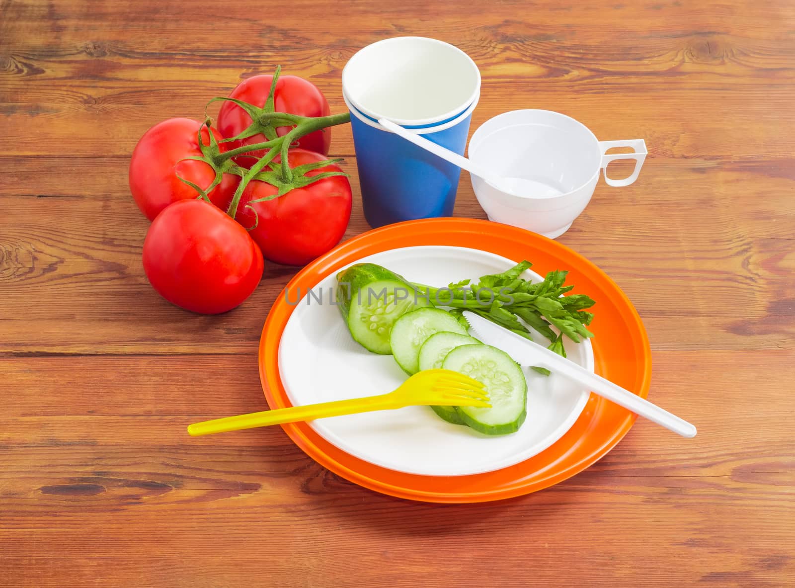 Disposable cutlery and several vegetable on wooden surface by anmbph