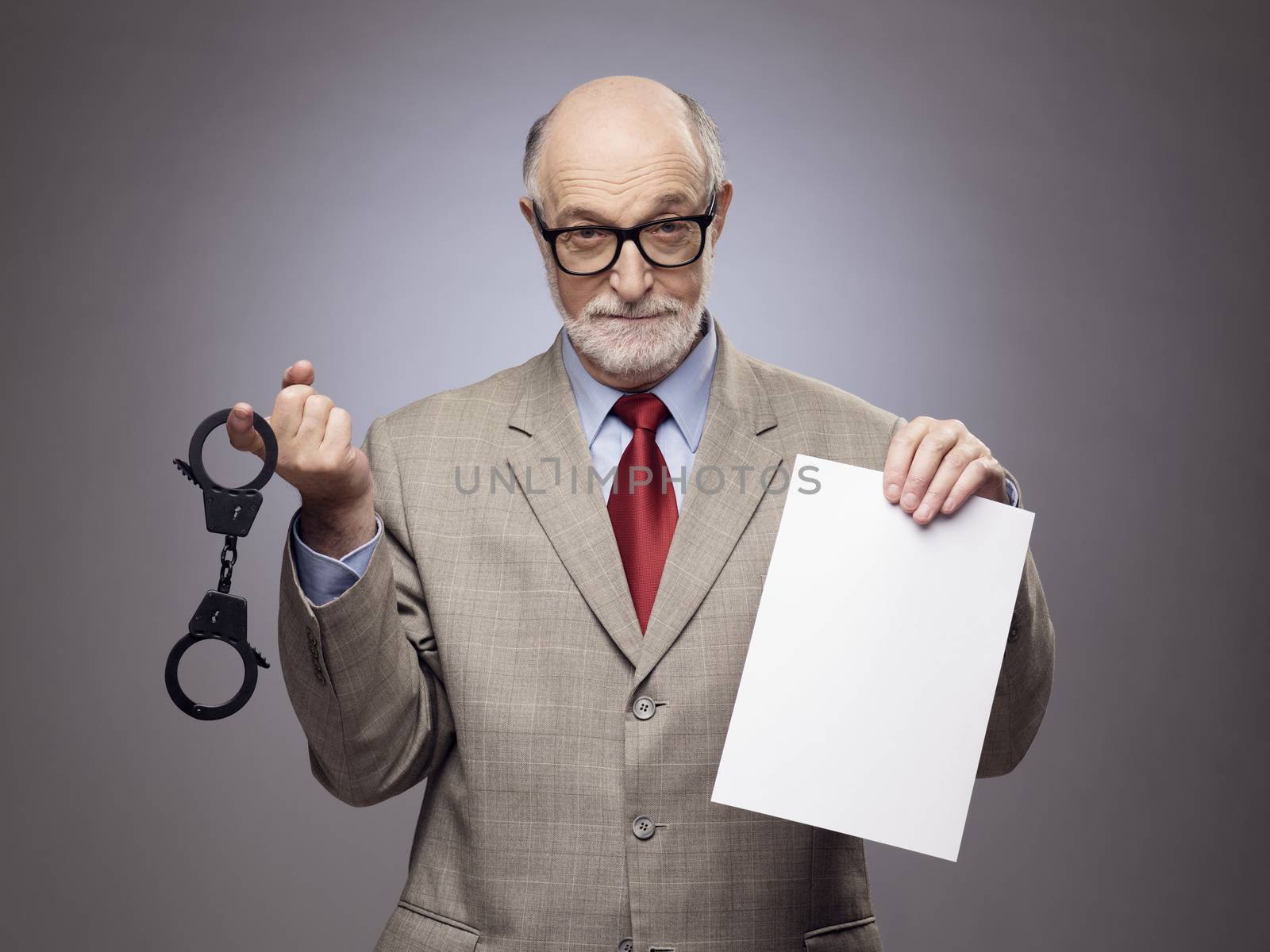 Senior man with handcuffs and paper by ALotOfPeople