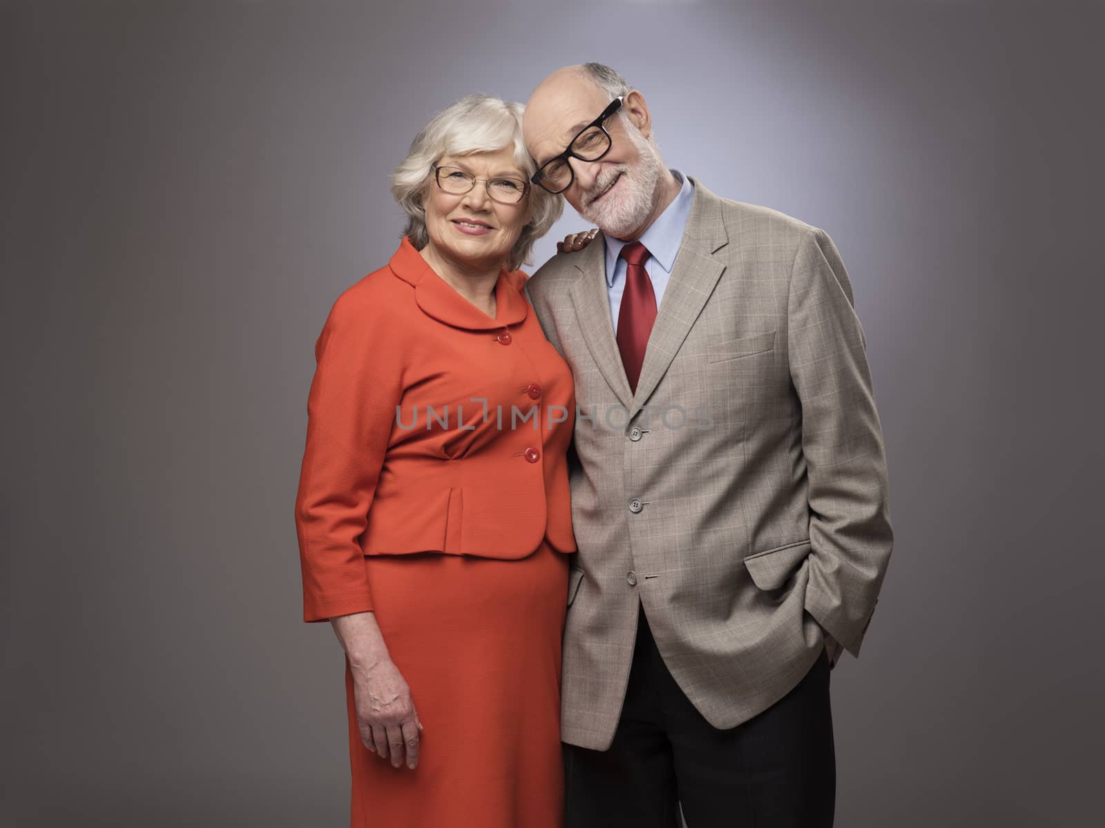 Studio portrait of senior couple on gray background