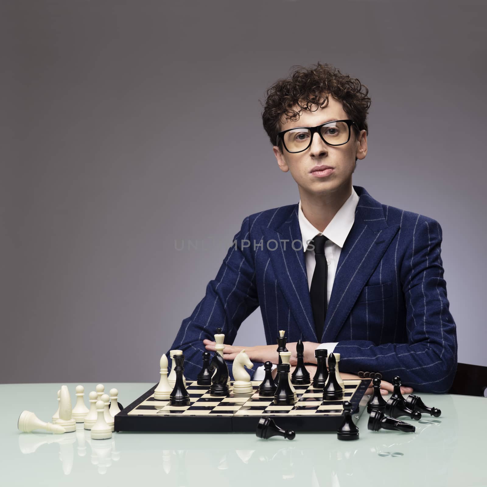 Studio portrait of successful man playing chess