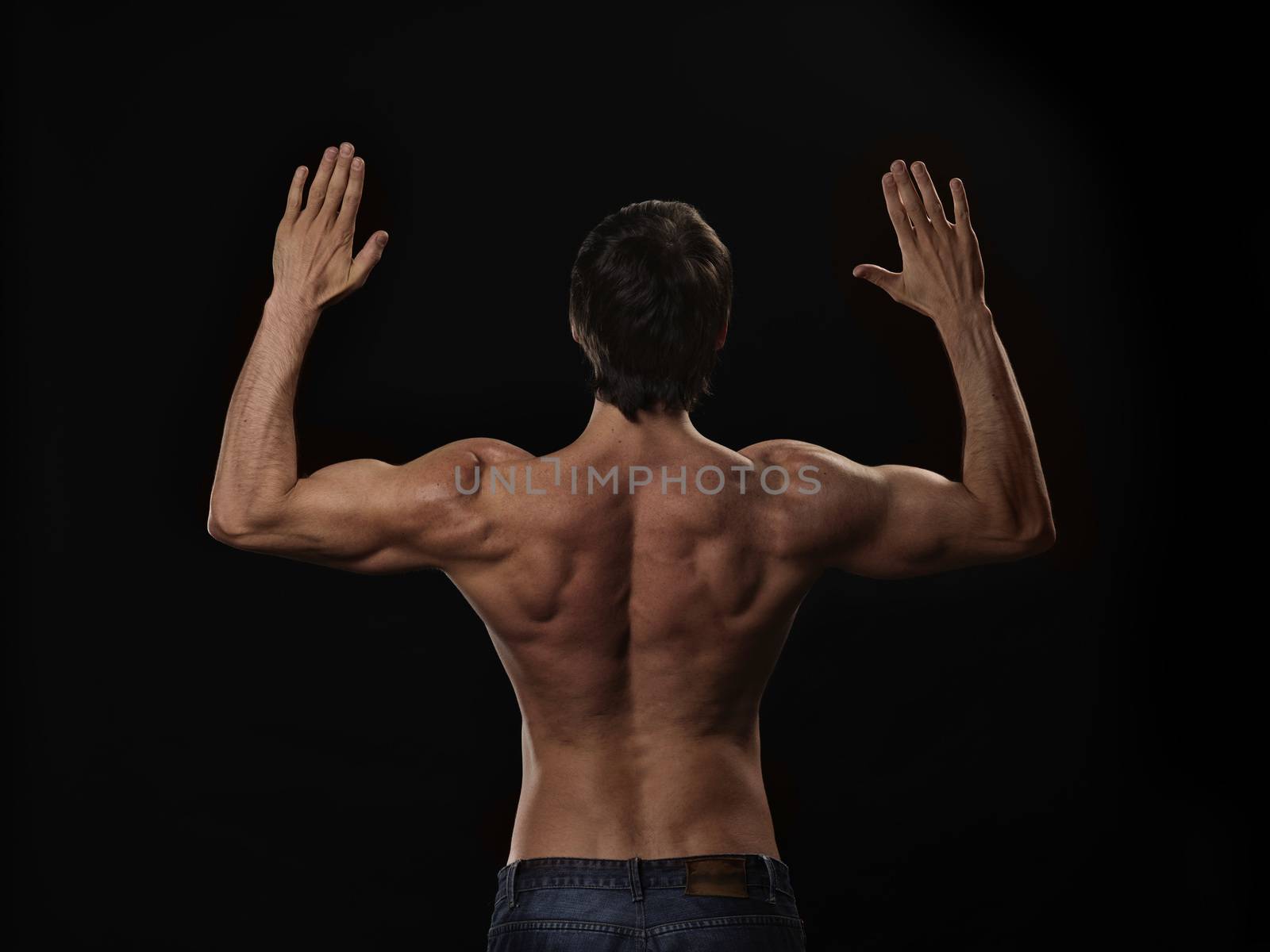 Muscular handsome sexy guy posing, isolated on black background