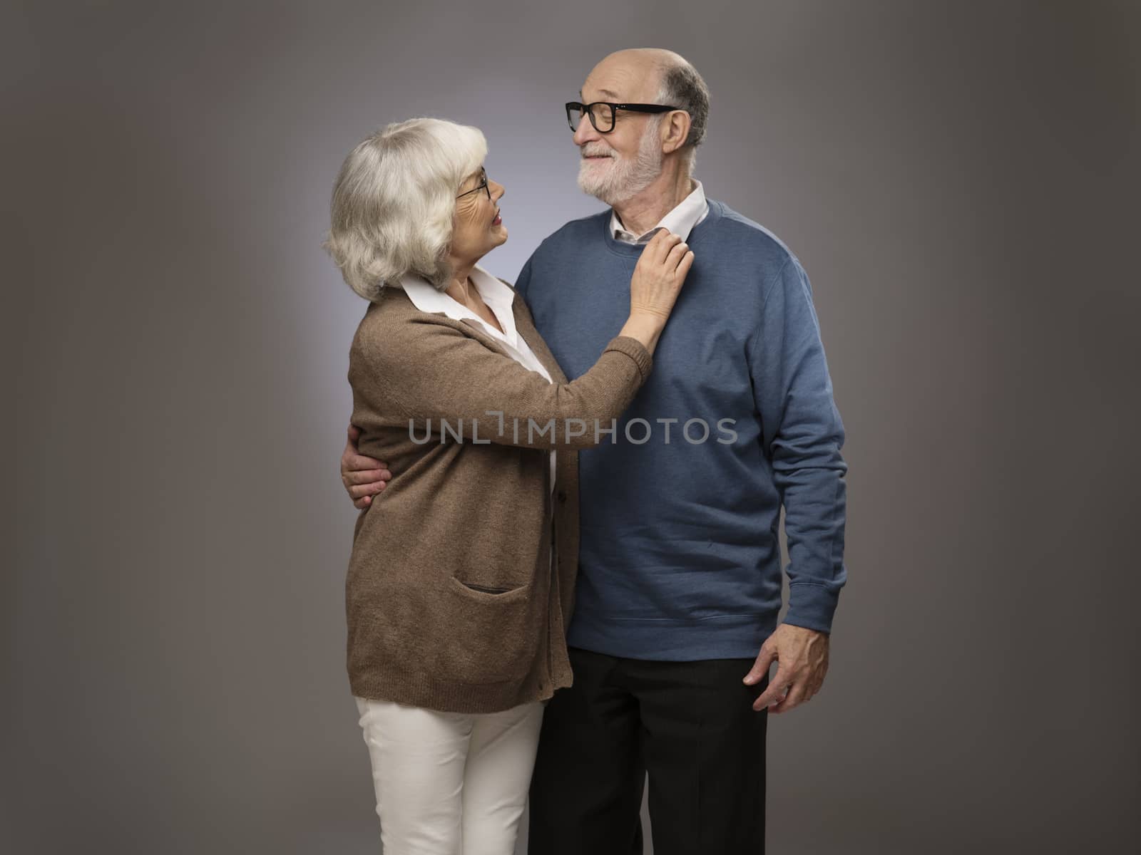 Studio portrait of senior couple on gray background