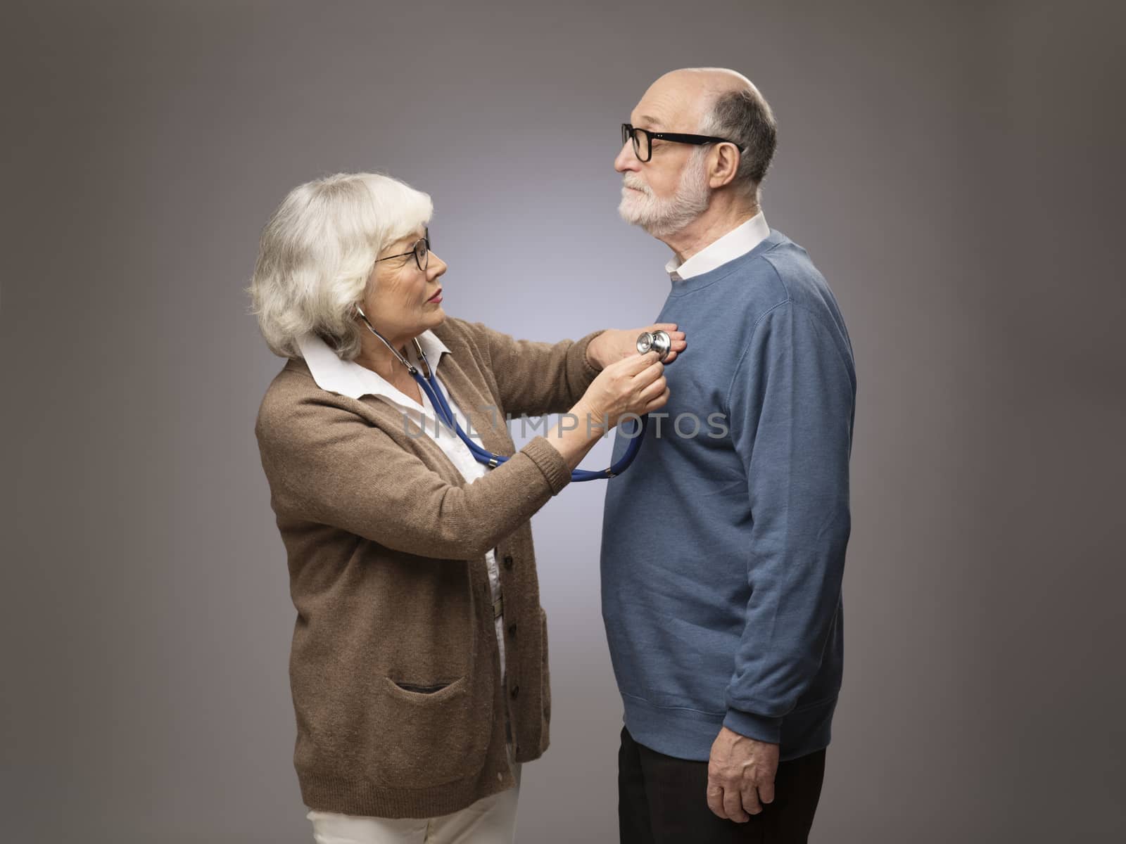 Senior woman checking heart beat by ALotOfPeople