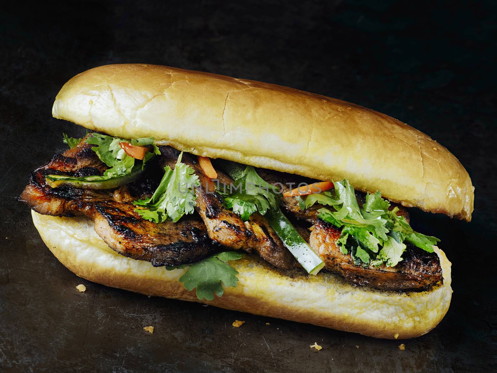 close up of rustic vietnamese bahn mi pork sandwich