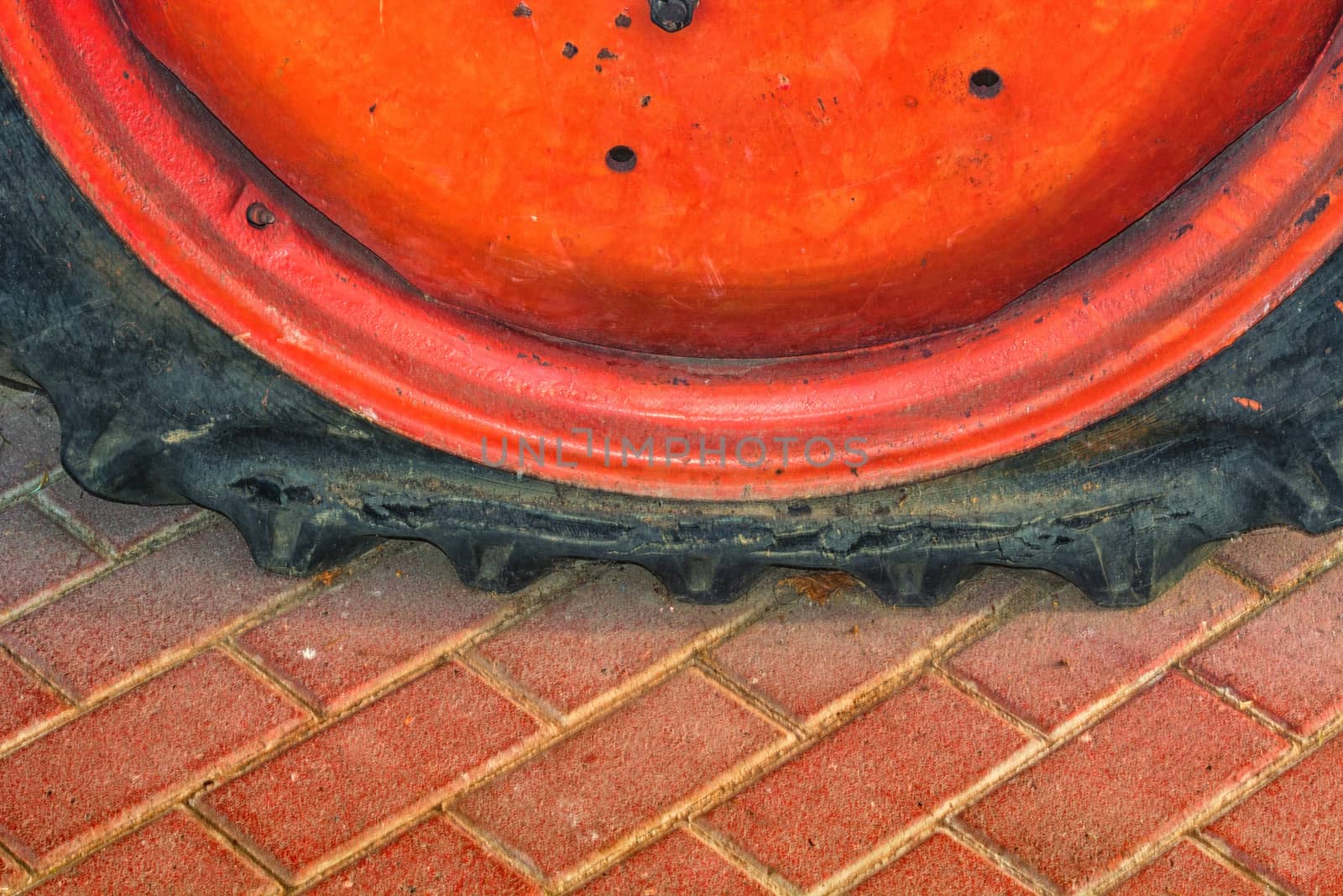Closeup of a damaged flat tire of a car or tractor on the road.