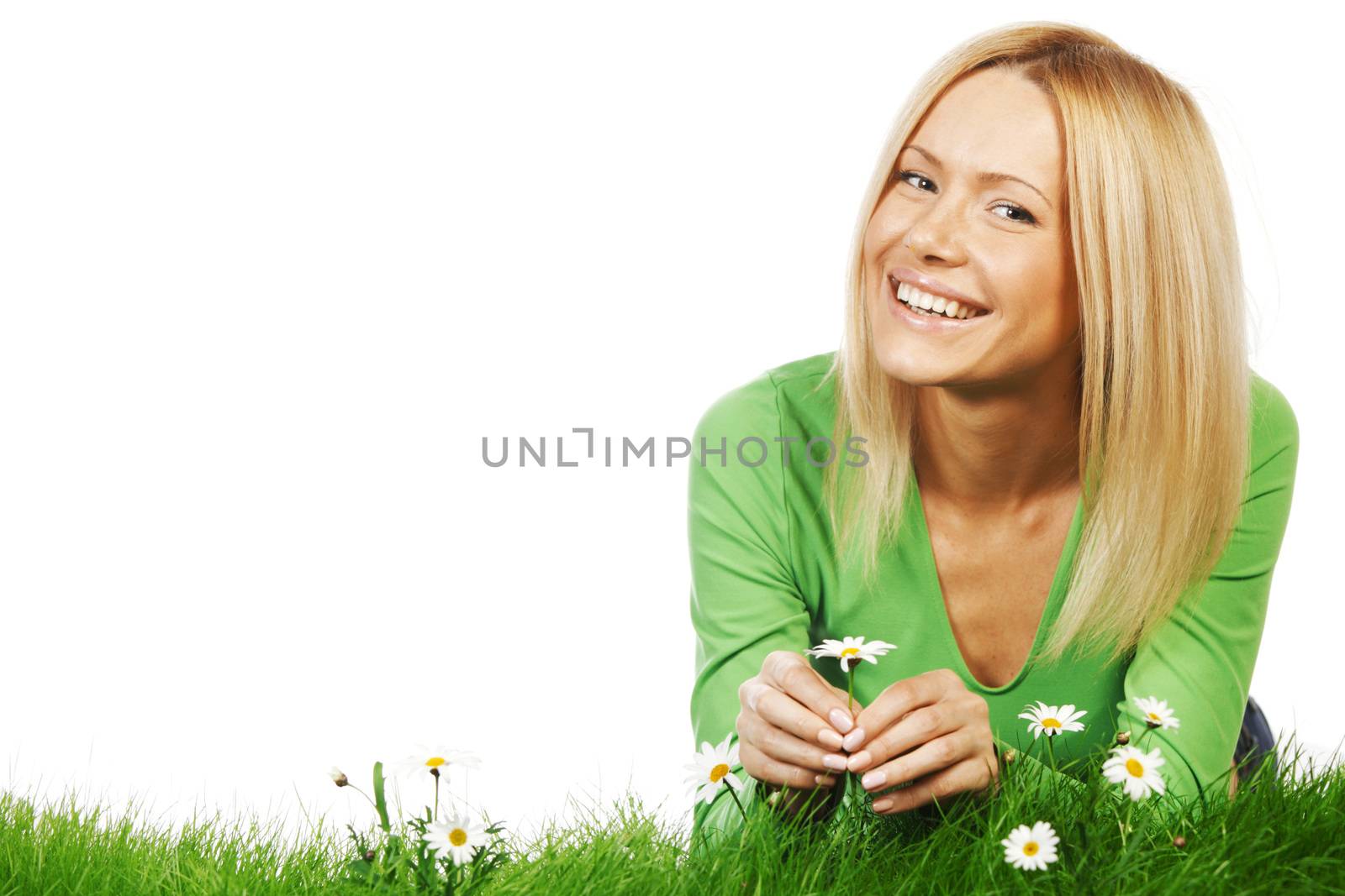 Happy young woman lying on grass with chamomile flowers, isolated on white background