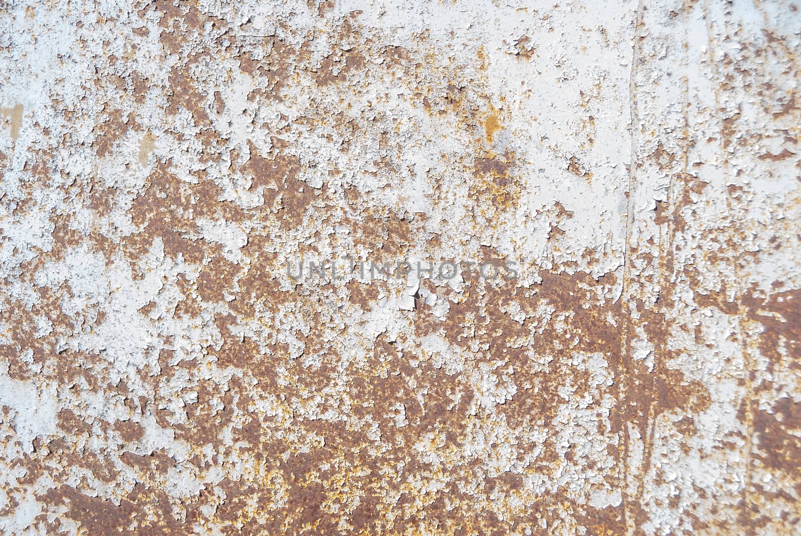 rusty iron surface covered with old chipped grey color paint, which has long been influenced by different climatic conditions