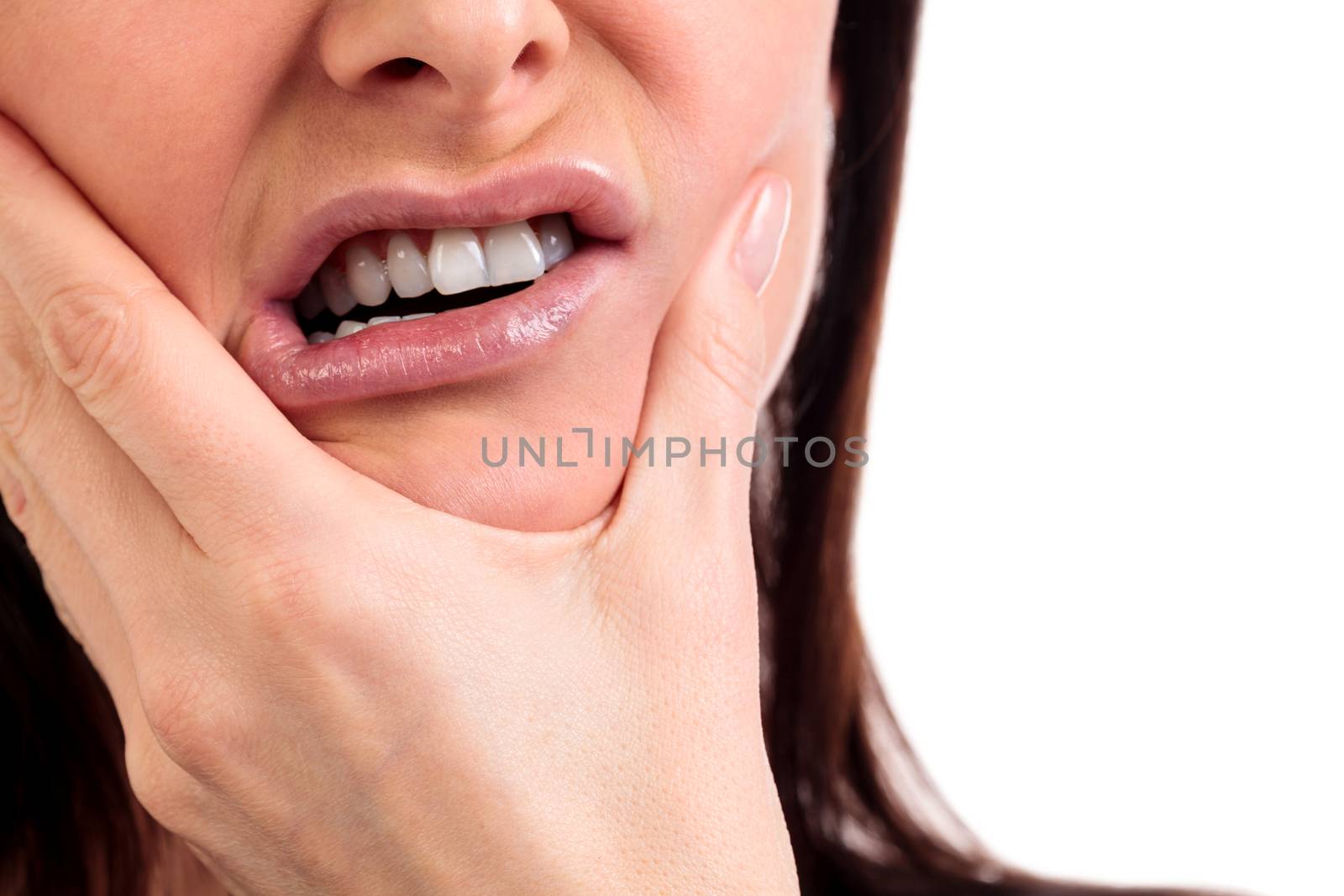 Closeup of woman in strong toothache pain with hands over face. Dental health and care concept. Isolated on white background.