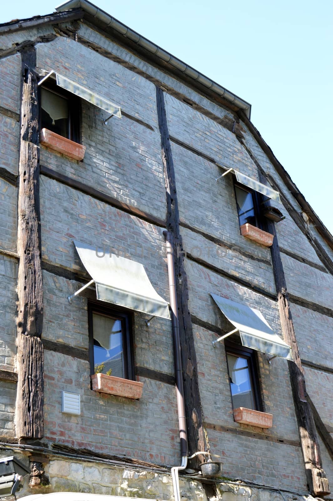 Half-timbered facade with blinds in windows