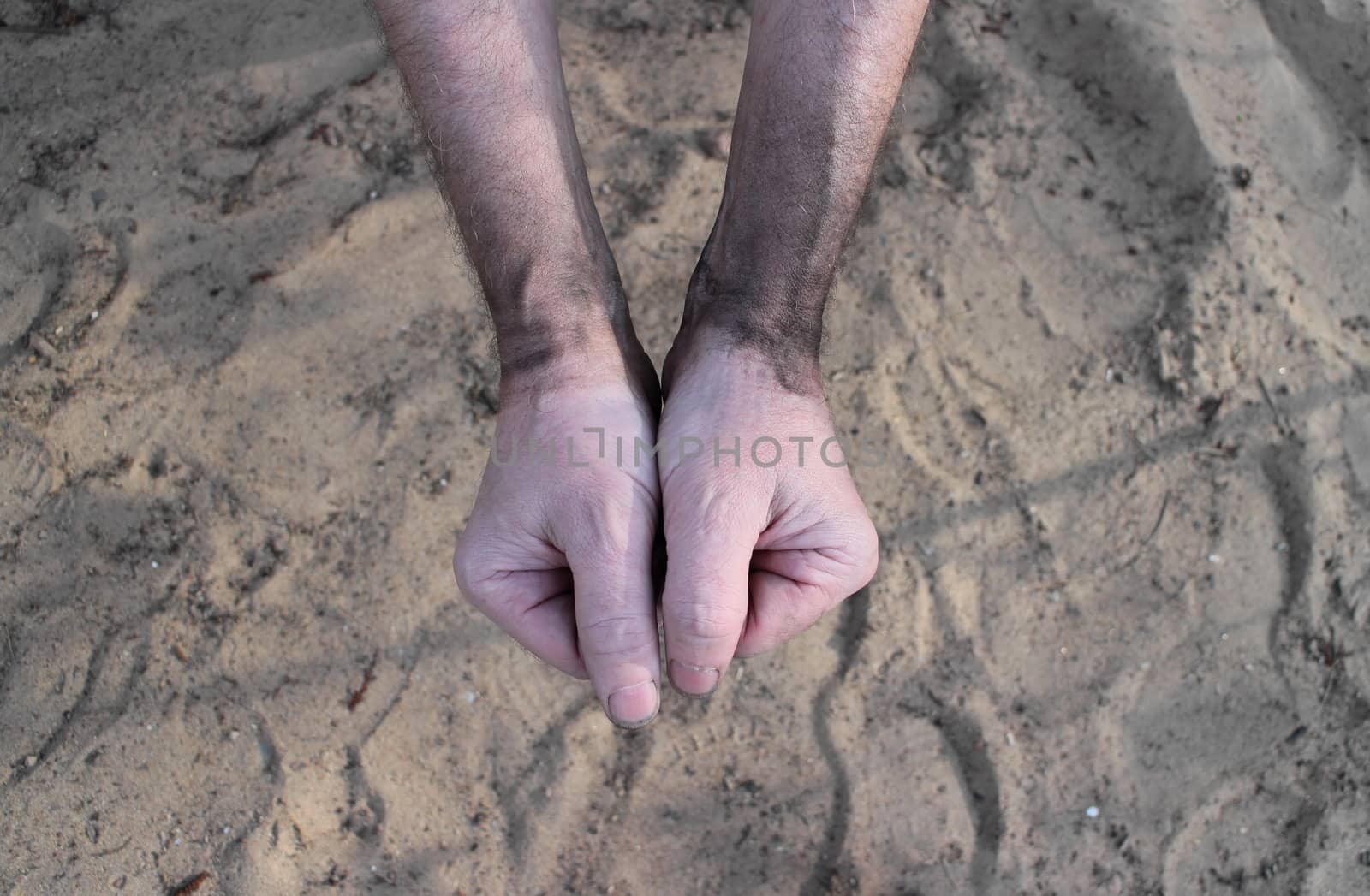 hands of miner soiled with soot close to