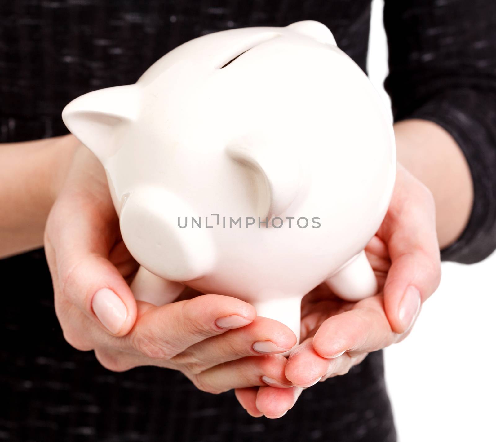 Closeup shot of woman's hands holding a piggy bank