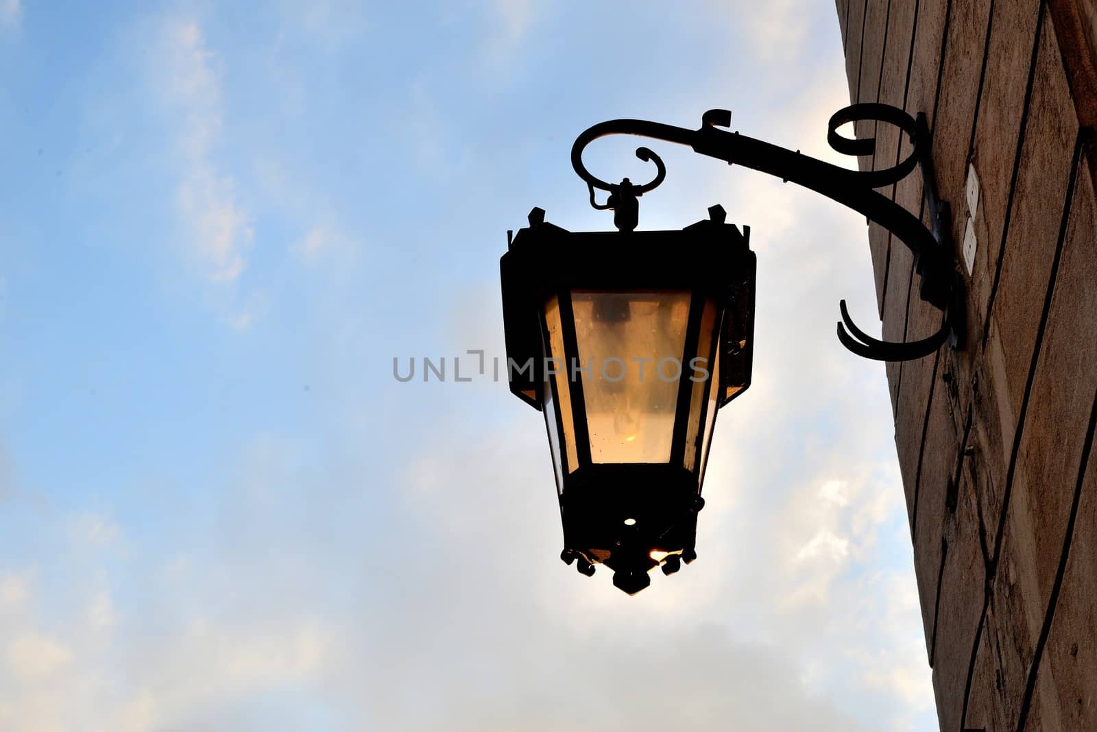 Old street lamp in Lublin illuminated by the sun