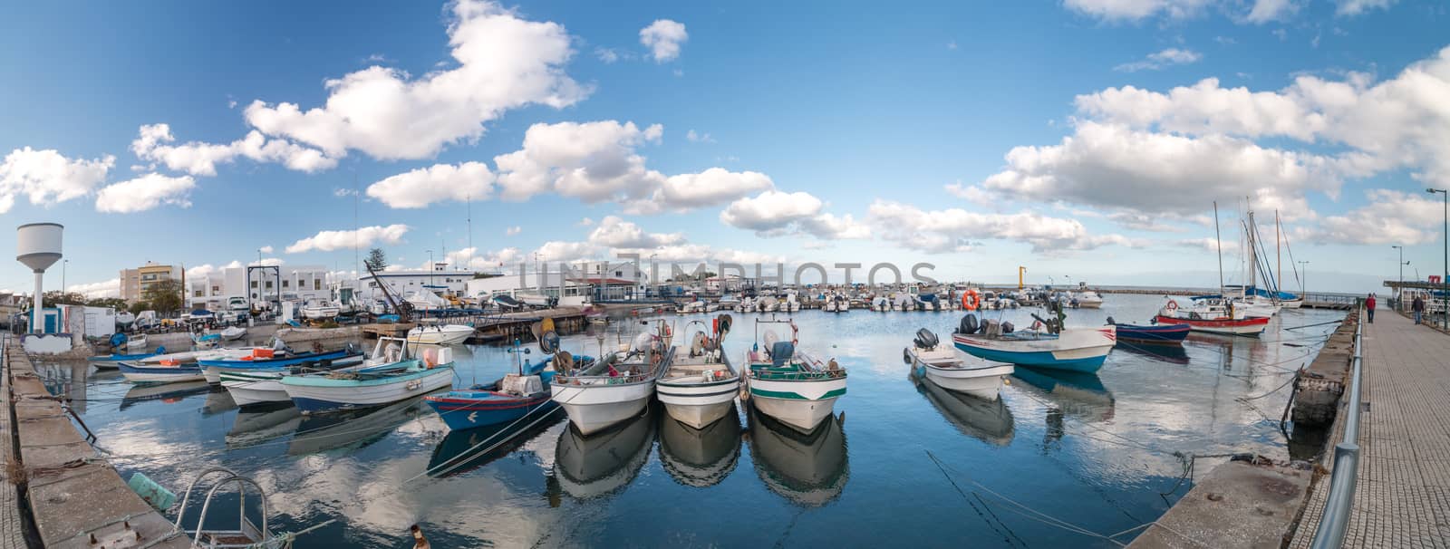 View of several traditional fishing boats on the port of Olhao, Portugal.