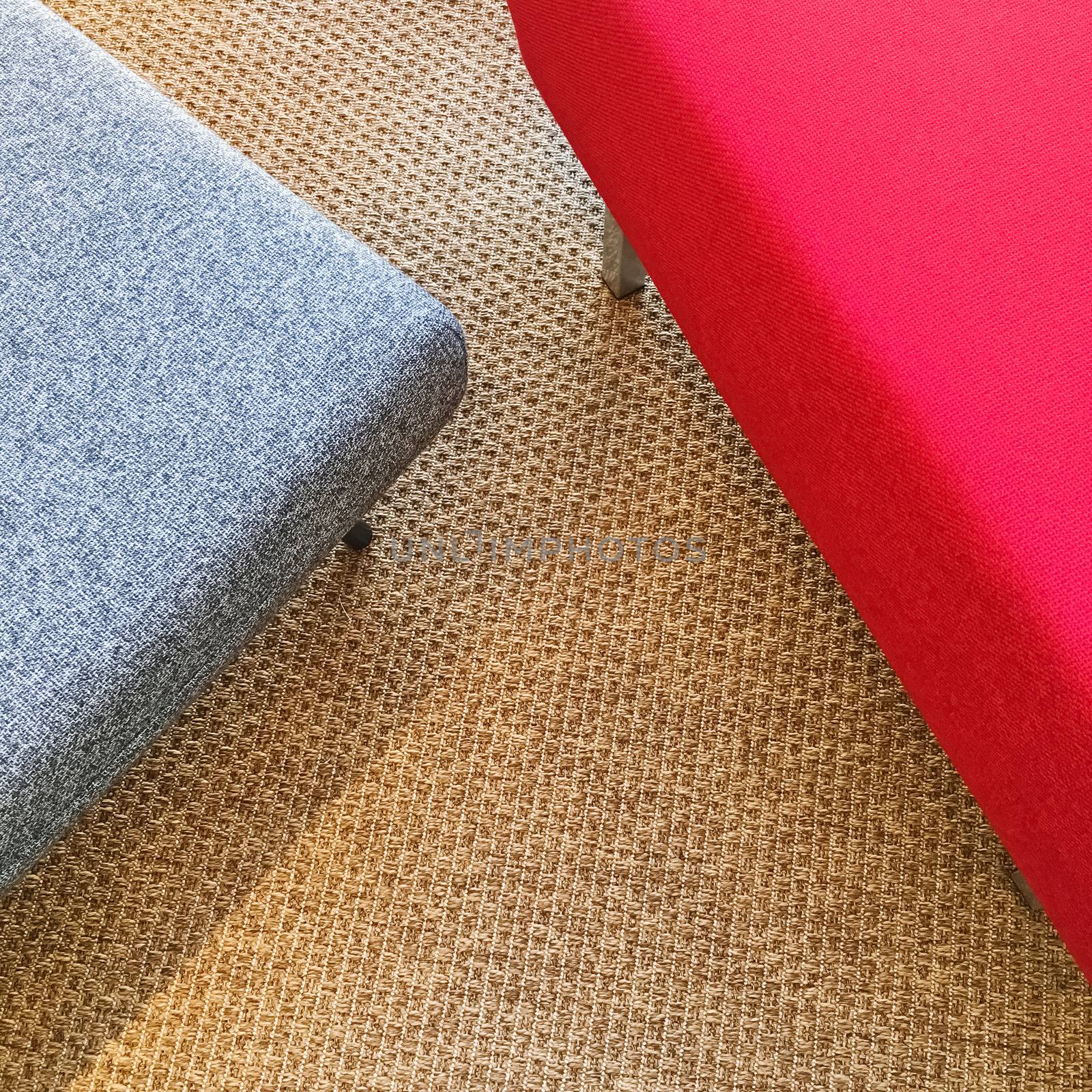 Red and gray seats on carpet floor. Modern furniture.