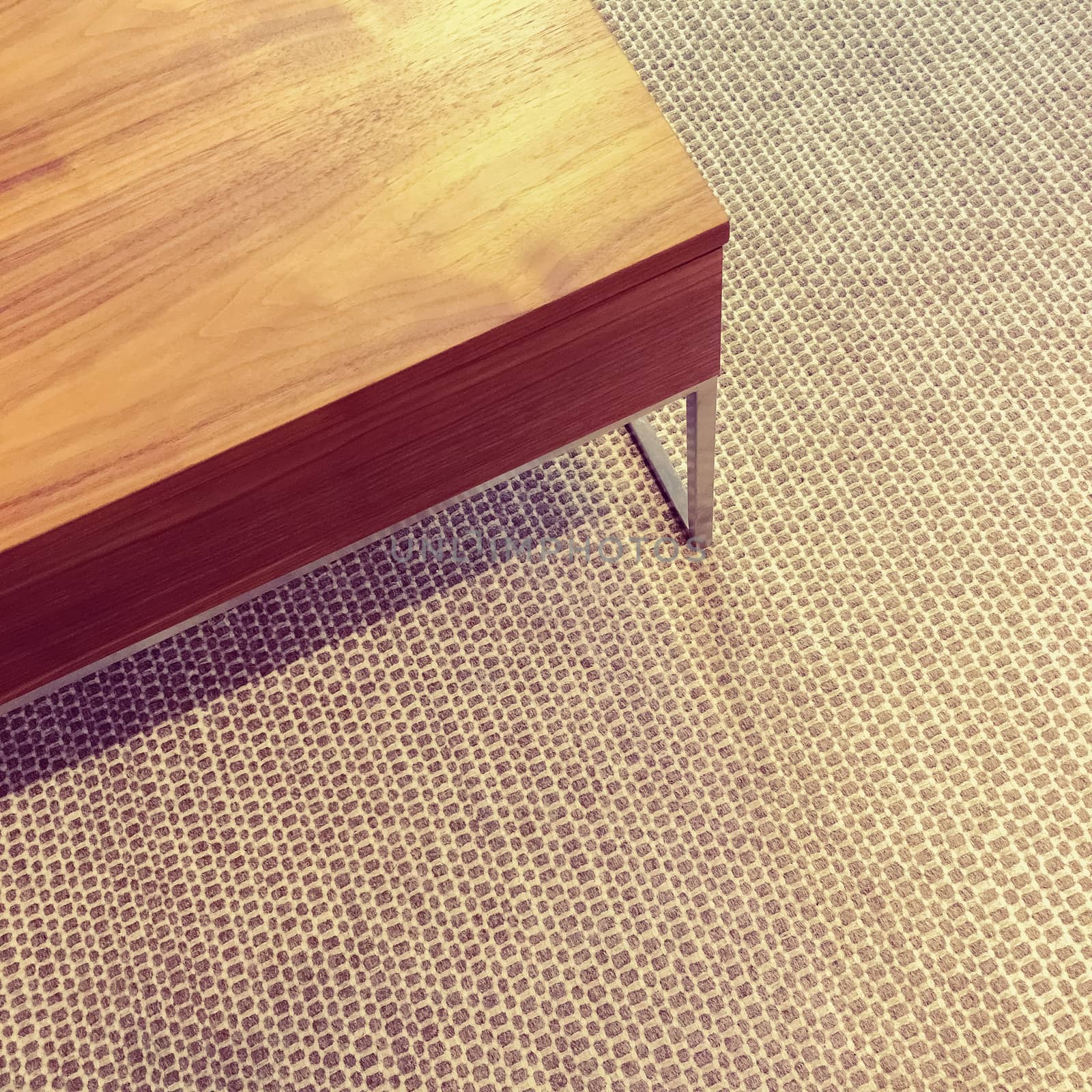 Simple wooden table on carpet floor by anikasalsera